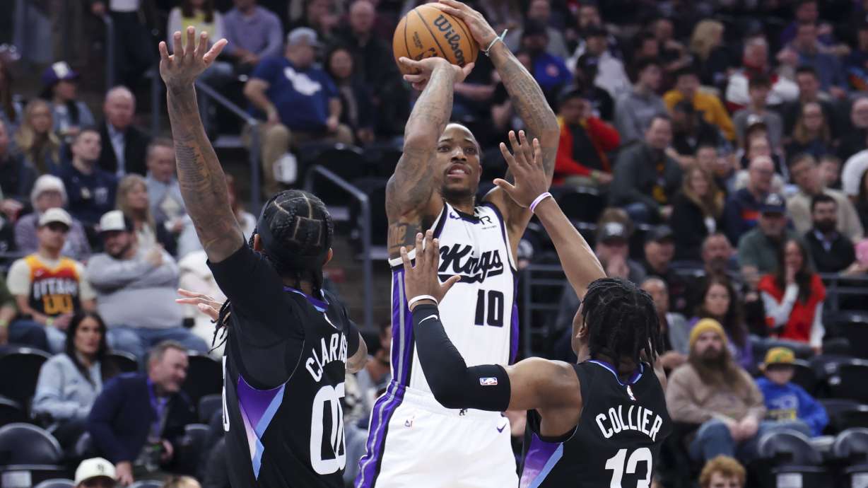Sacramento Kings forward DeMar DeRozan (10) shoots over Utah Jazz guard Jordan Clarkson and guard Isaiah Collier (13) during the first half of an NBA basketball game, Wednesday, Feb. 26, 2025, in Salt Lake City.