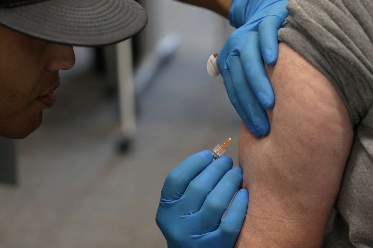 Matt Caldwell, left, a Lubbock Fire Department official, administers a measles, mumps and rubella vaccine to Clair May, 61, at the Lubbock Health Department, Wednesday, Feb. 26, 2025, in Lubbock, Texas.