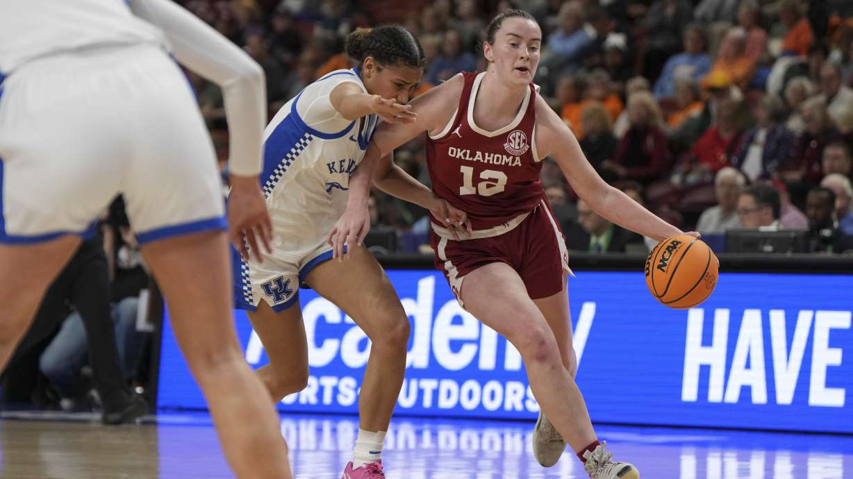 Oklahoma guard Payton Verhulst (12) drives the ball around a Kentucky defender during an NCAA college basketball game in the quarterfinals of the Southeastern Conference tournament, Friday, March 7, 2025, in Greenville, S.C.