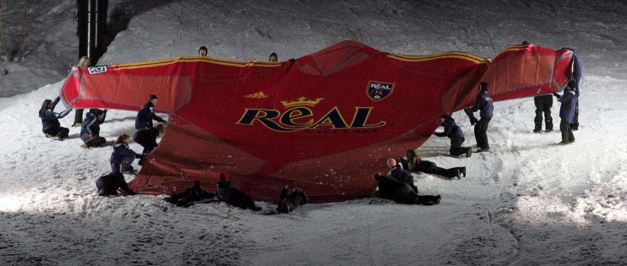 A crew unfurls a 60-foot version of the new Salt Lake Real jersey during an event unveiling the team's new design at a celebration in Park City on Saturday, March 12, 2005.