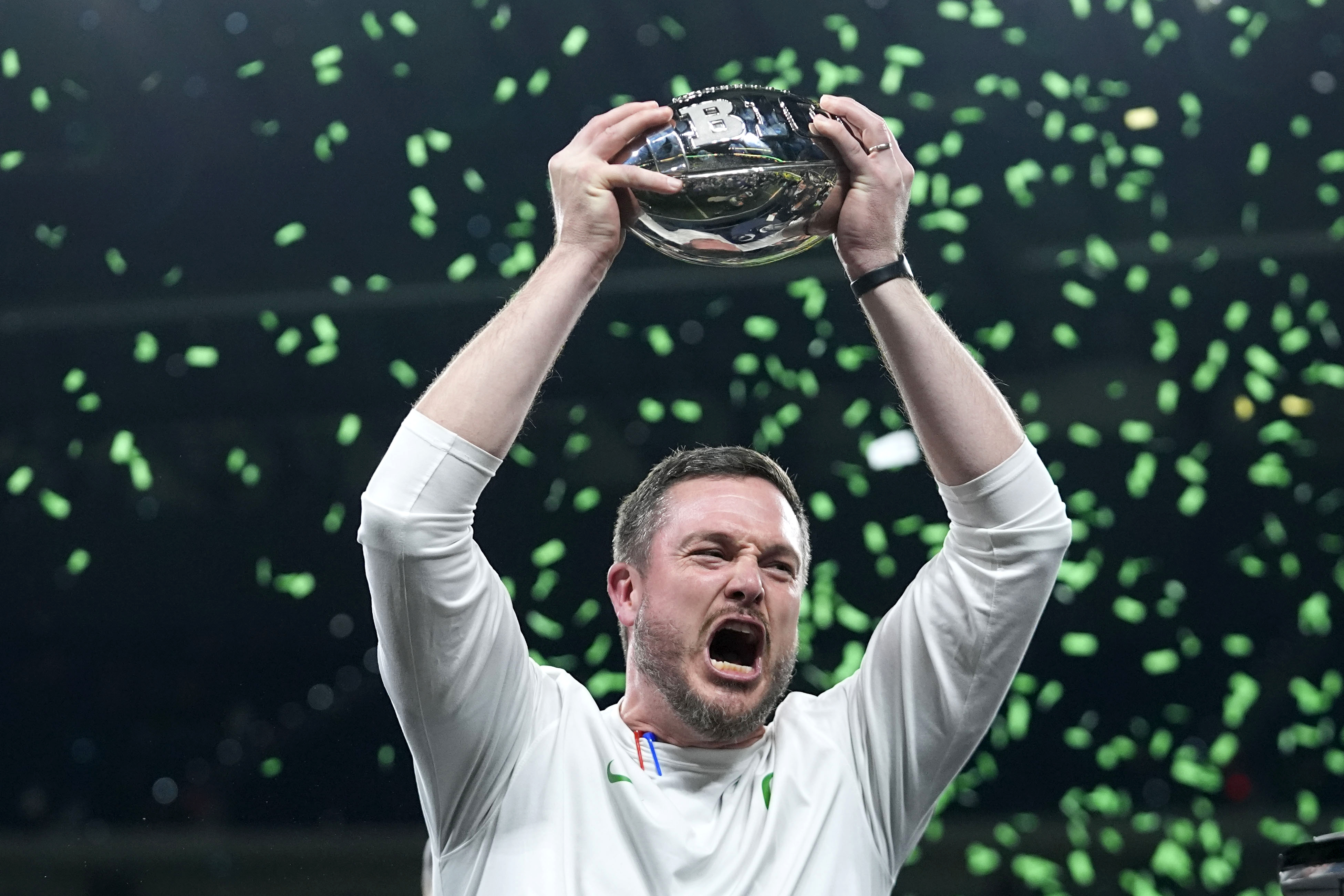 FILE- Oregon head coach Dan Lanning celebrates with the trophy after defeating against Penn State in the Big Ten Conference championship NCAA college football game, Saturday, Dec. 7, 2024, in Indianapolis. 