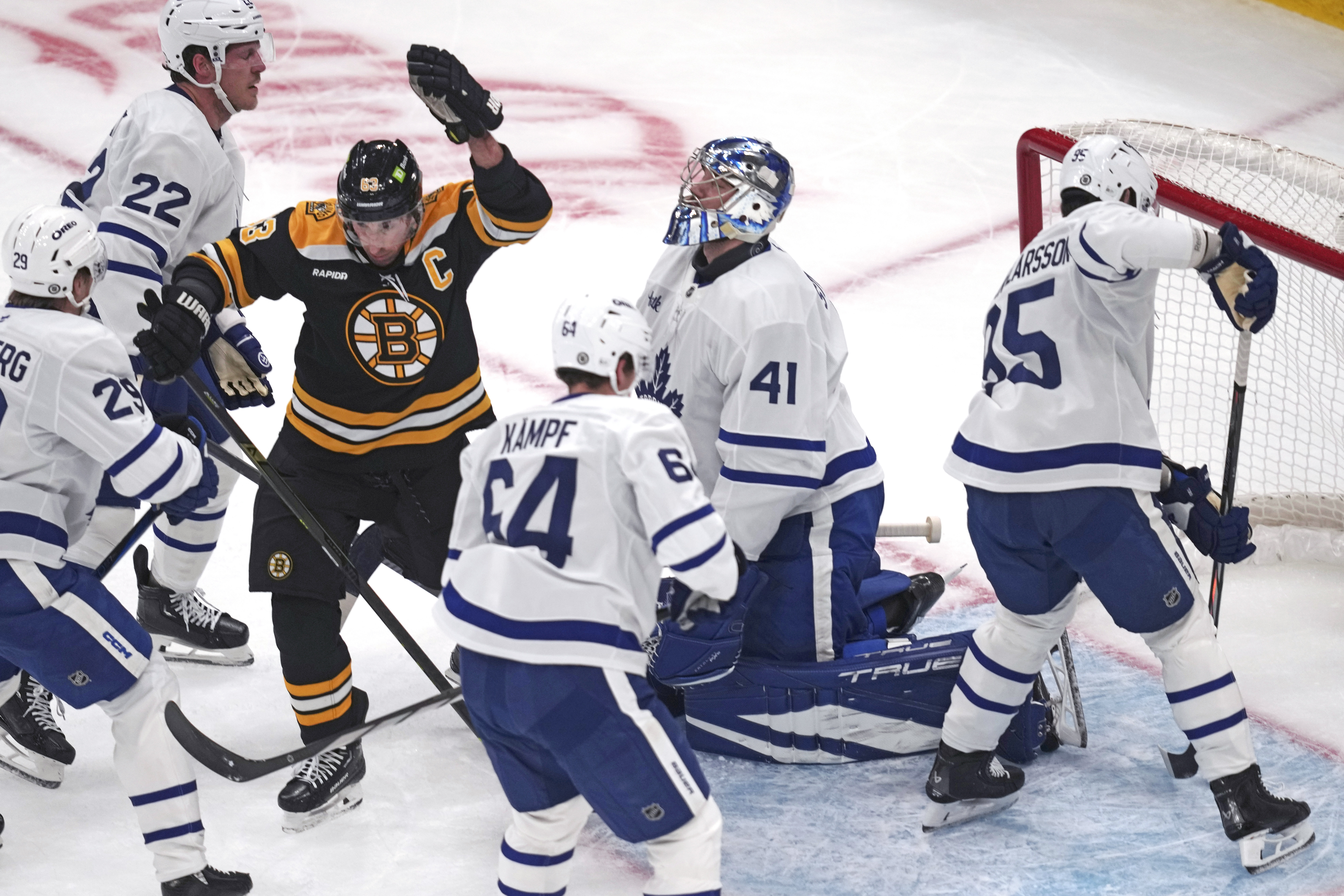 Boston Bruins left wing Brad Marchand (63) raises his arm after scoring against Toronto Maple Leafs goaltender Anthony Stolarz (41) during the first period of an NHL hockey game, Tuesday, Feb. 25, 2025, in Boston.