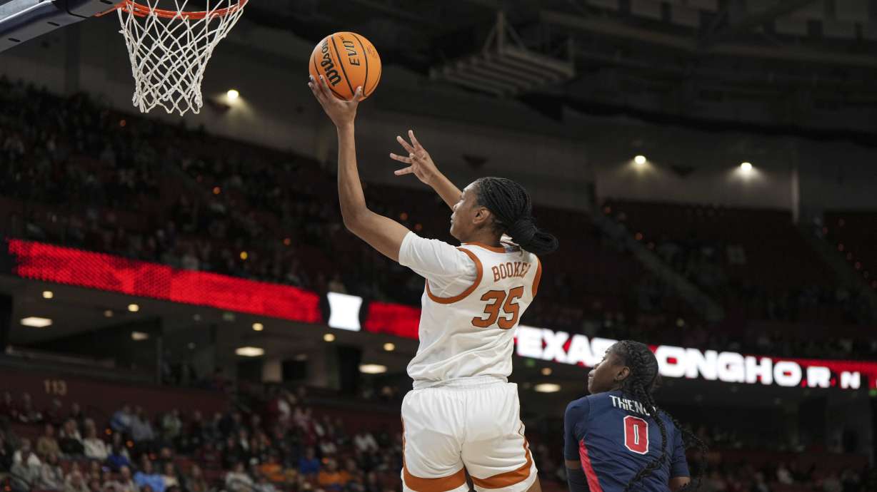 Texas forward Madison Booker (35) shoots over Mississippi guard Sira Thienou (0) during an NCAA college basketball game in the quarterfinals of the Southeastern Conference tournament, Friday, March 7, 2025, in Greenville, S.C.