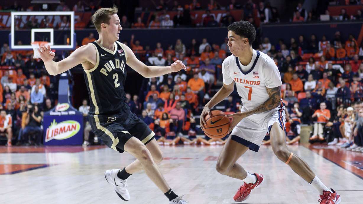 Illinois' Will Riley, right, advances the ball against Purdue's Fletcher Loyer, left, during the first half of an NCAA college basketball game, Friday, March 7, 2025, in Champaign, Ill.