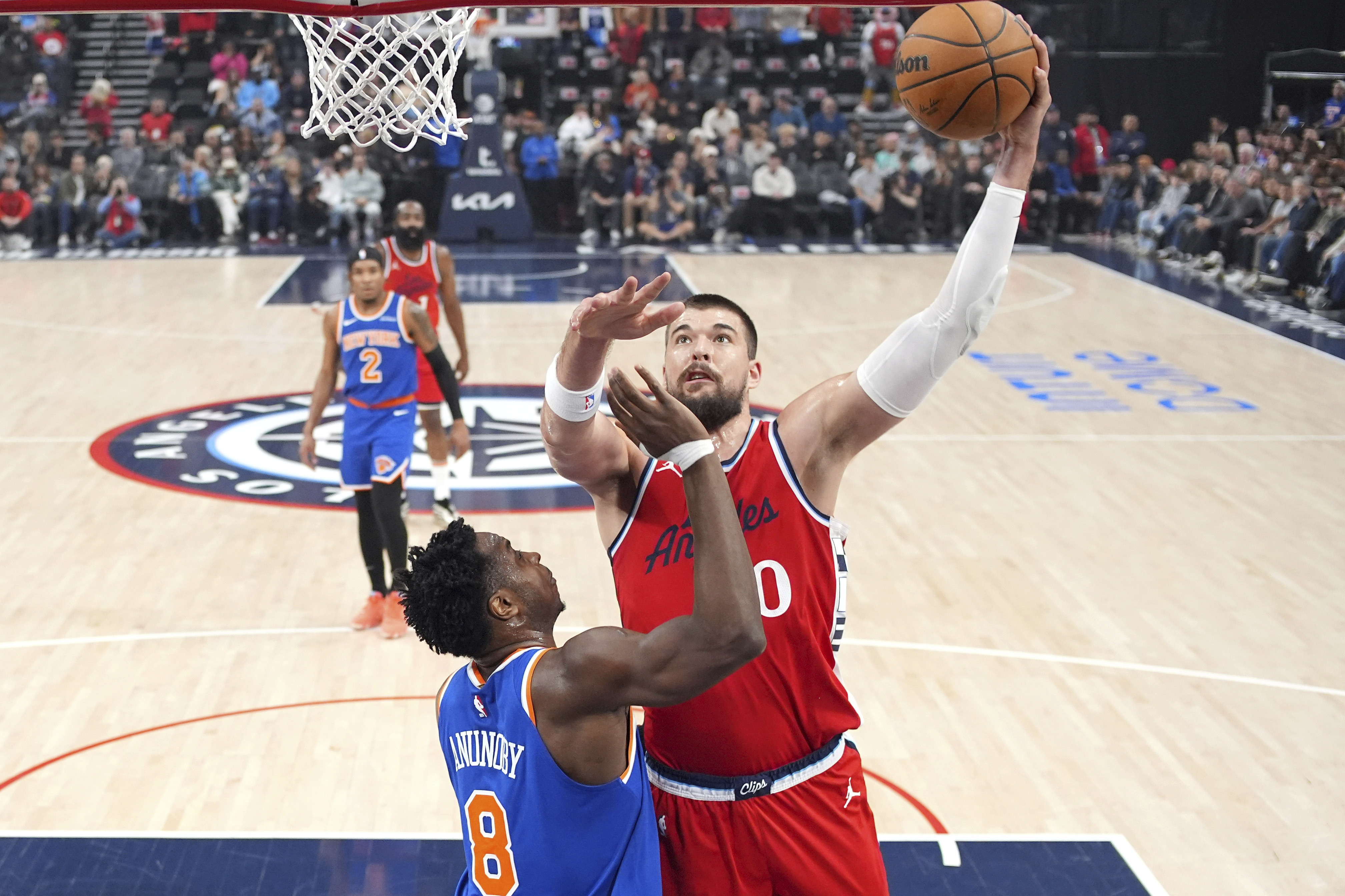 Los Angeles Clippers center Ivica Zubac, right, shoots as New York Knicks forward OG Anunoby defends during the first half of an NBA basketball game Friday, March 7, 2025, in Inglewood, Calif. 