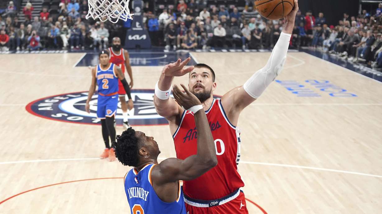 Los Angeles Clippers center Ivica Zubac, right, shoots as New York Knicks forward OG Anunoby defends during the first half of an NBA basketball game Friday, March 7, 2025, in Inglewood, Calif.