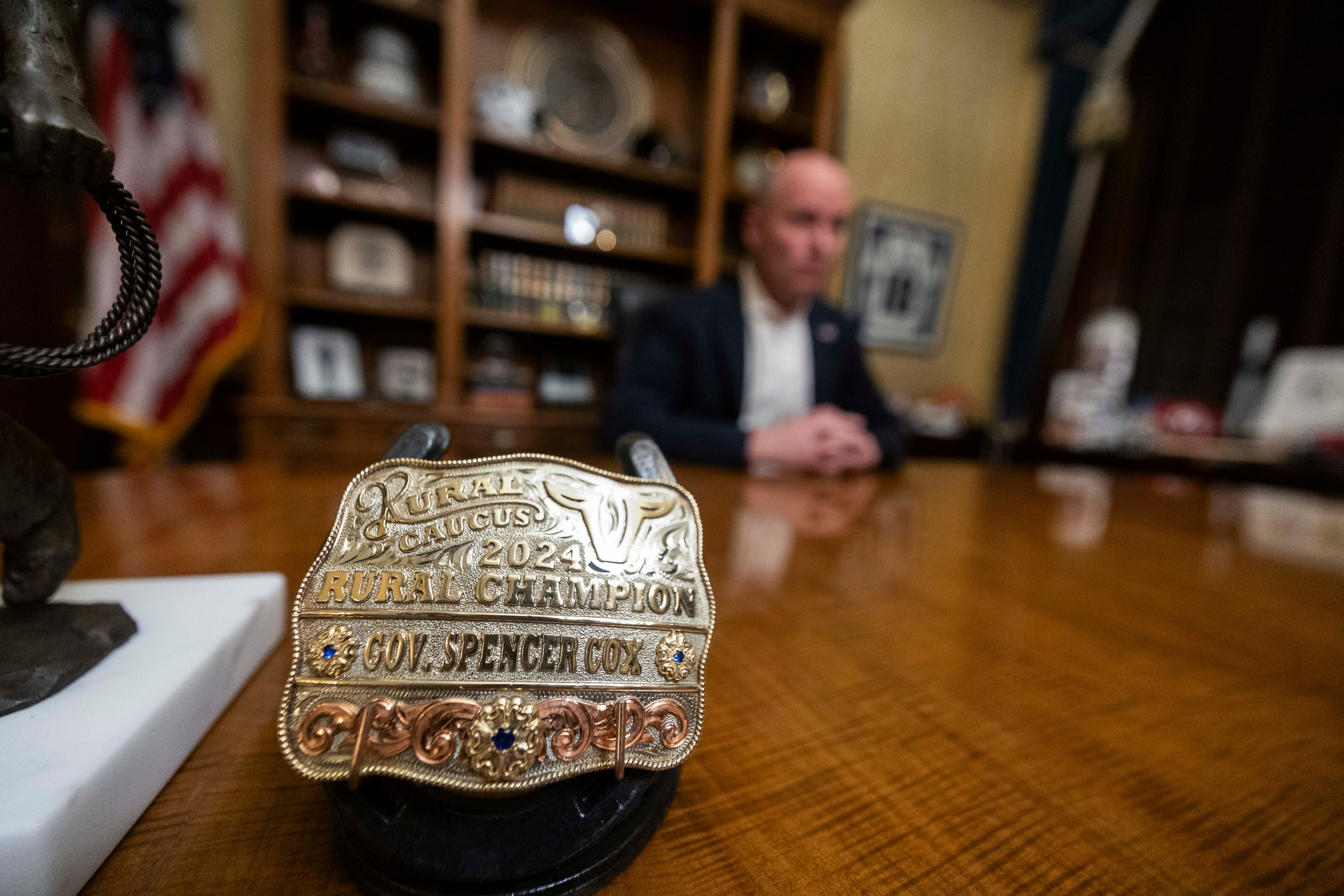 A belt buckle awarded to Gov. Spencer Cox from Utah's Rural Caucus sits on his desk while answering questions during an interview with the Deseret News on the last day of the 2025 legislative session, in his formal office at the Capitol in Salt Lake City on Friday, March 7.