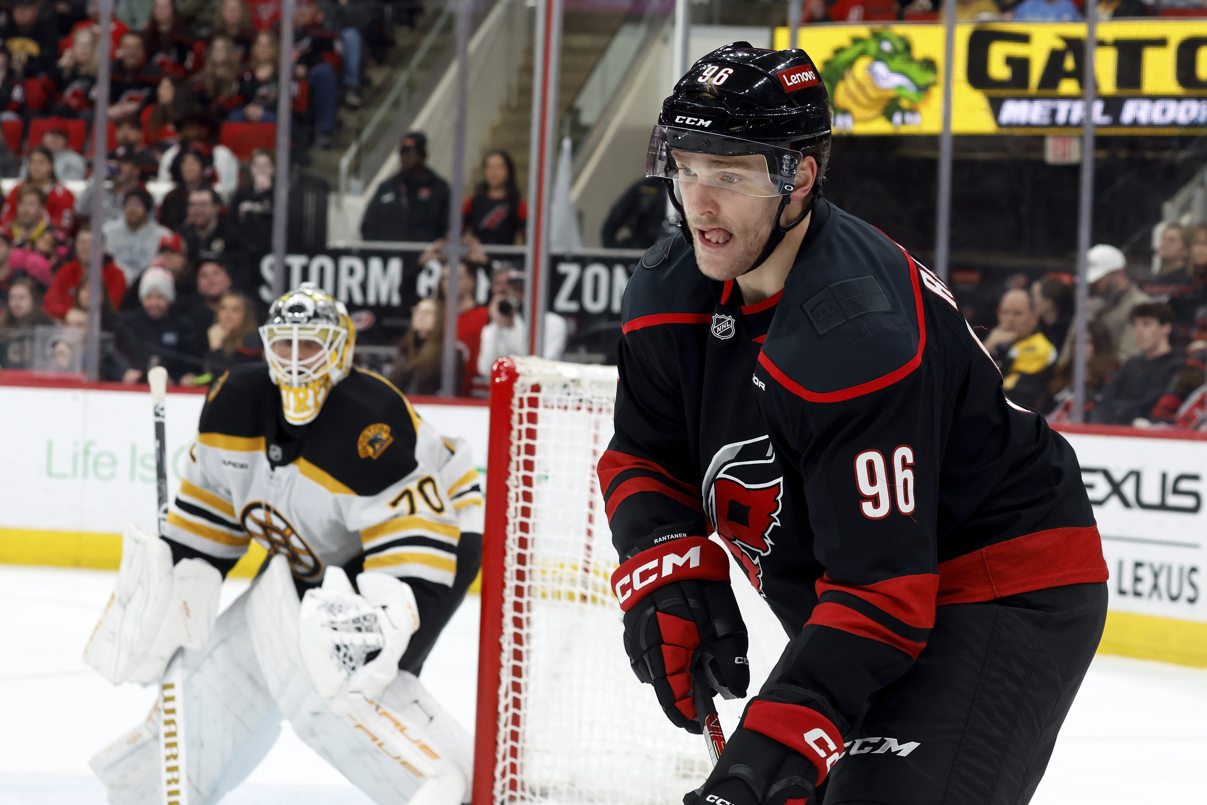 Carolina Hurricanes' Mikko Rantanen (96) concentrates on the puck as Boston Bruins goaltender Joonas Korpisalo (70) looks on during the second period of an NHL hockey game in Raleigh, N.C., Thursday, March 6, 2025.