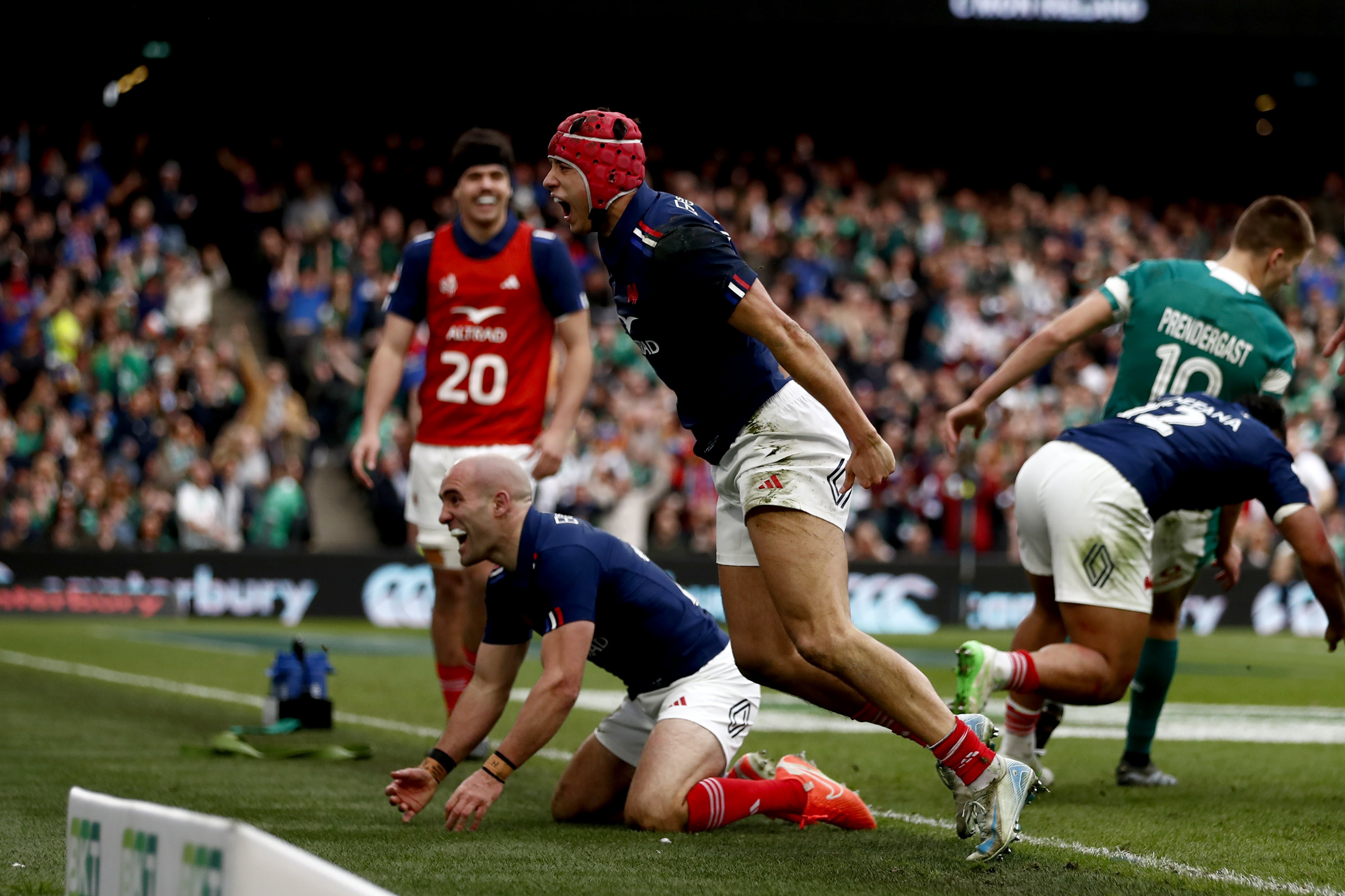 France's Louis Bielle-Biarrey, centre, celebrates with his teammate Maxime Lucu, after scoring a try during the Six Nations rugby union match between Ireland and France, at Aviva Stadium, Dublin, Ireland, Saturday, March 8, 2025. 