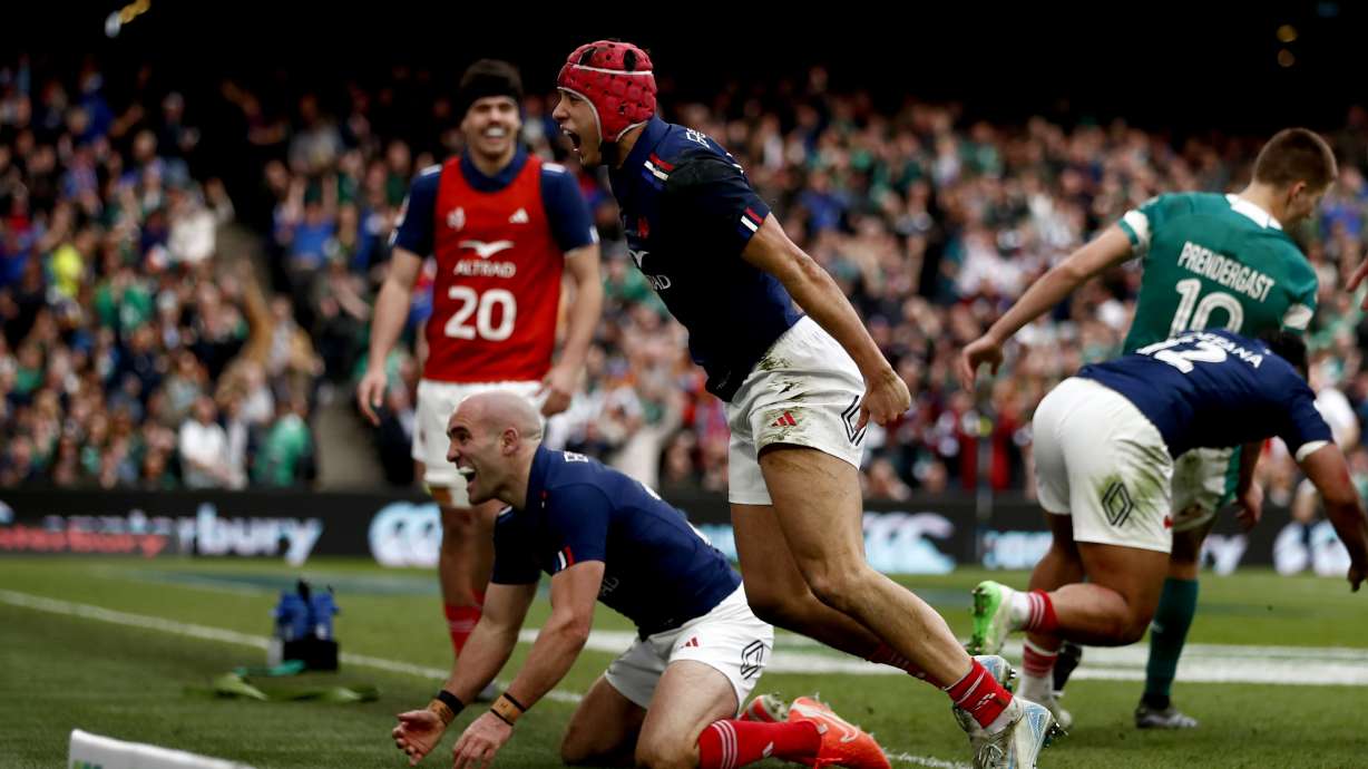 France's Louis Bielle-Biarrey, centre, celebrates with his teammate Maxime Lucu, after scoring a try during the Six Nations rugby union match between Ireland and France, at Aviva Stadium, Dublin, Ireland, Saturday, March 8, 2025.