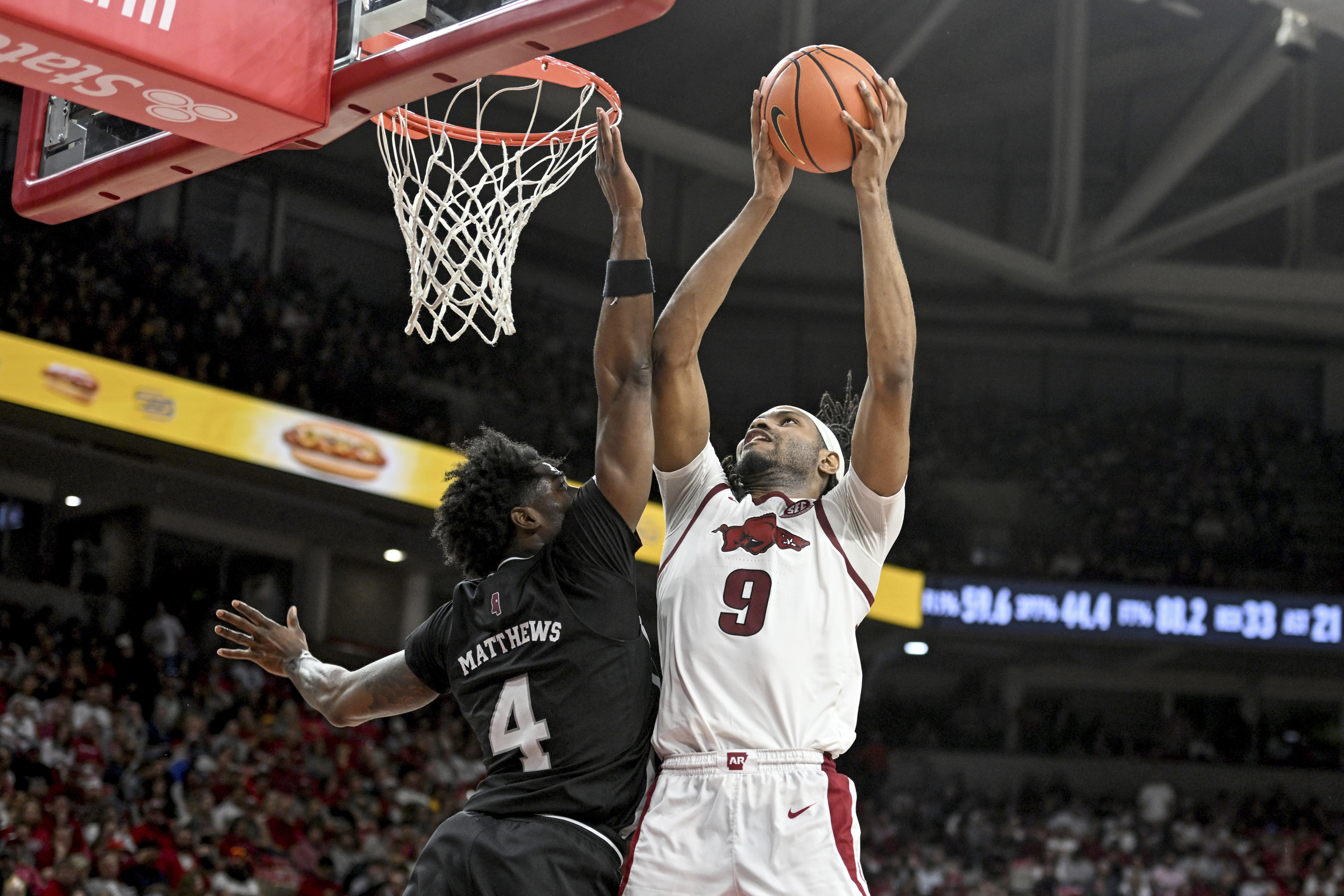Arkansas forward Jonas Aidoo (9) shoots over Mississippi State forward Cameron Matthews (4) during the second half of an NCAA college basketball game Saturday, March 8, 2025, in Fayetteville, Ark. 