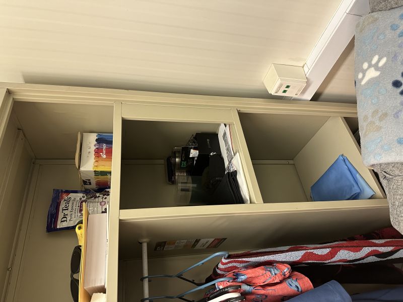 The corner of a cubby in Army Maj. Kenton L. Francis's office, taken right after a woman found a phone hidden behind paper packaging to record her changing. - Anonymous