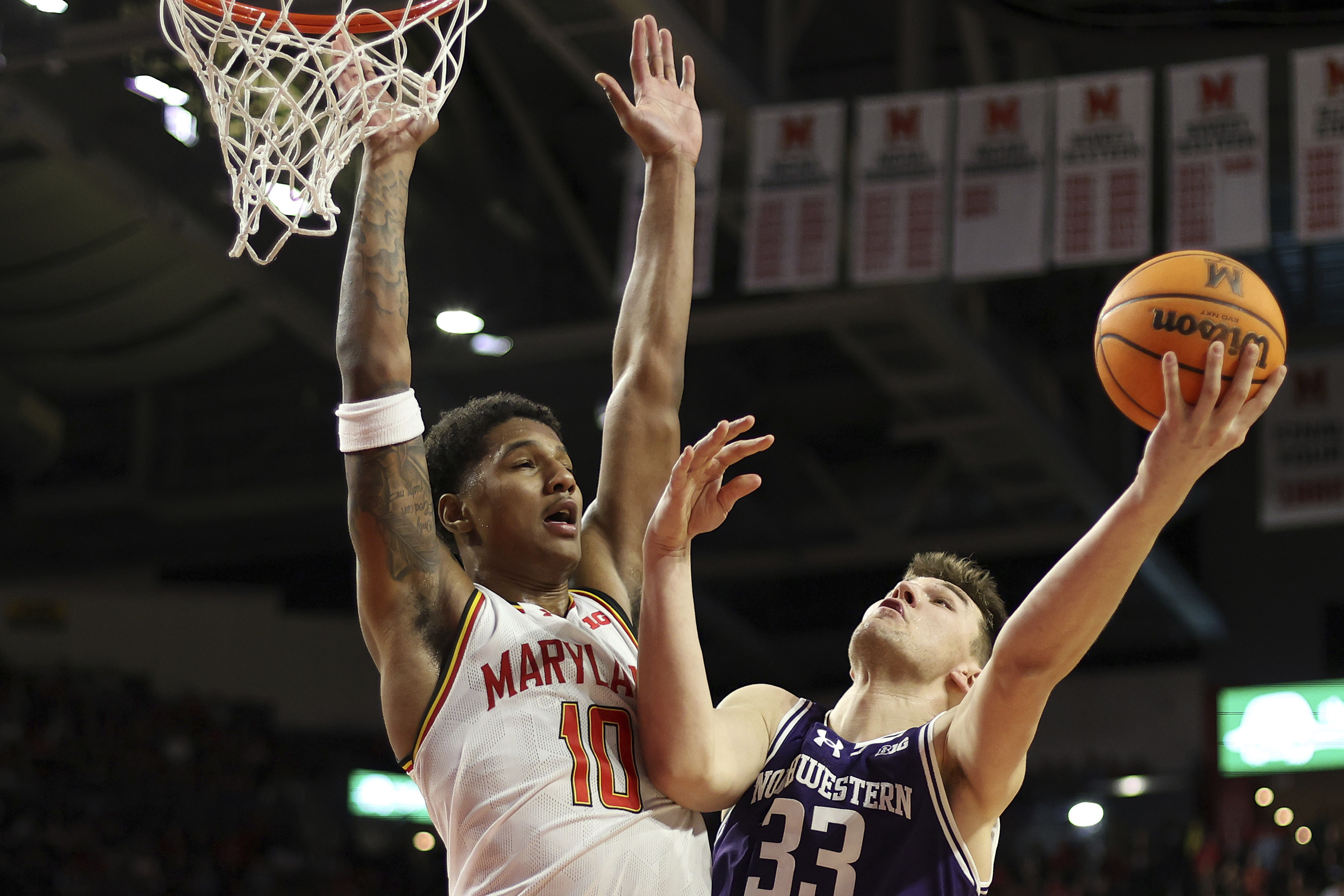 Northwestern forward Luke Hunger (33) takes a shot over Maryland forward Julian Reese (10) during the first half of an NCAA college basketball game, Saturday, March 8, 2025, in College Park, Md.