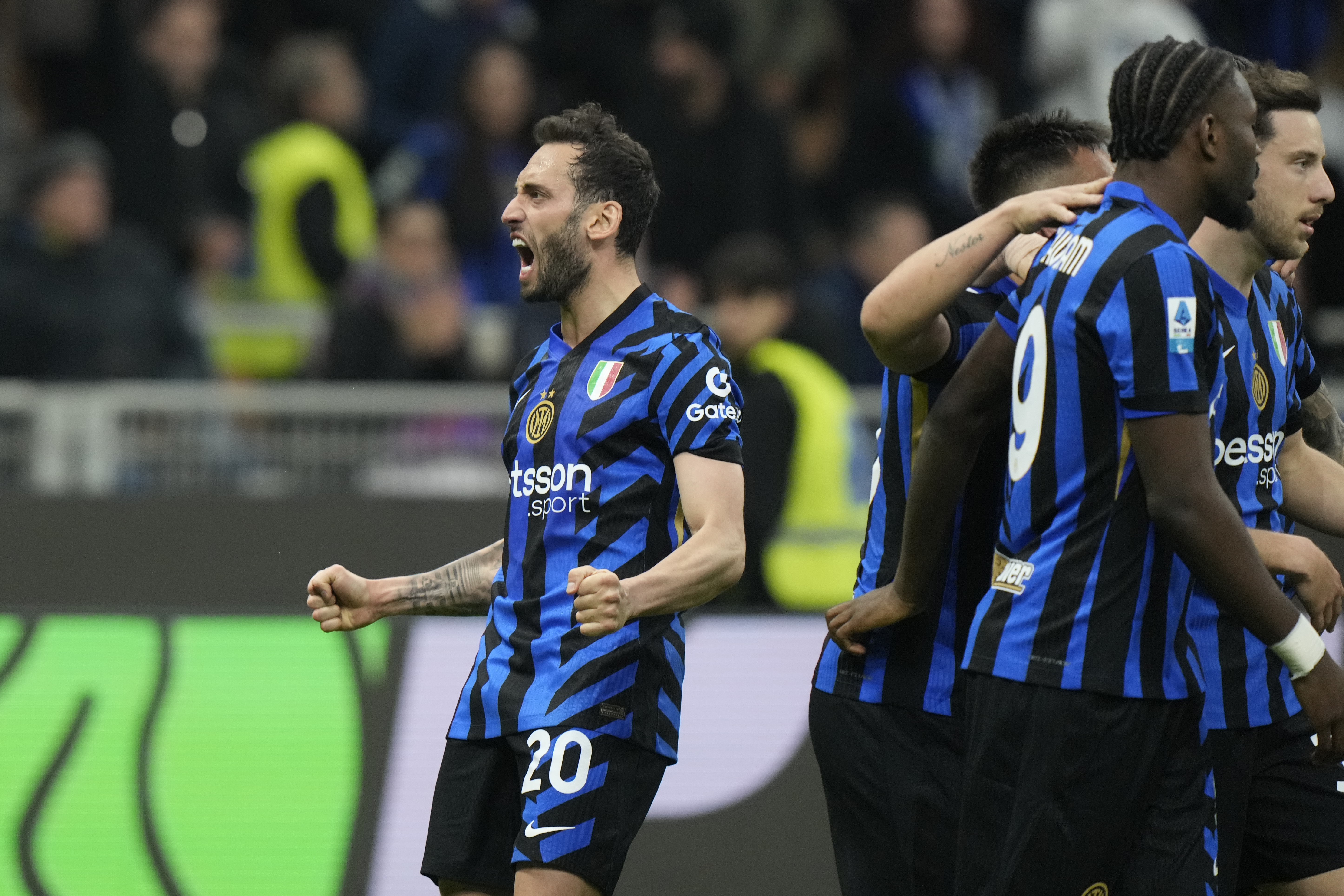 Inter Milan's Hakan Calhanoglu celebrates his side's third goal, an own goal scored by Monza's Giorgos Kyriakopoulos, during the Serie A soccer match between Inter Milan and Monza at the San Siro stadium in Milan, Italy, Saturday, March 8, 2025.