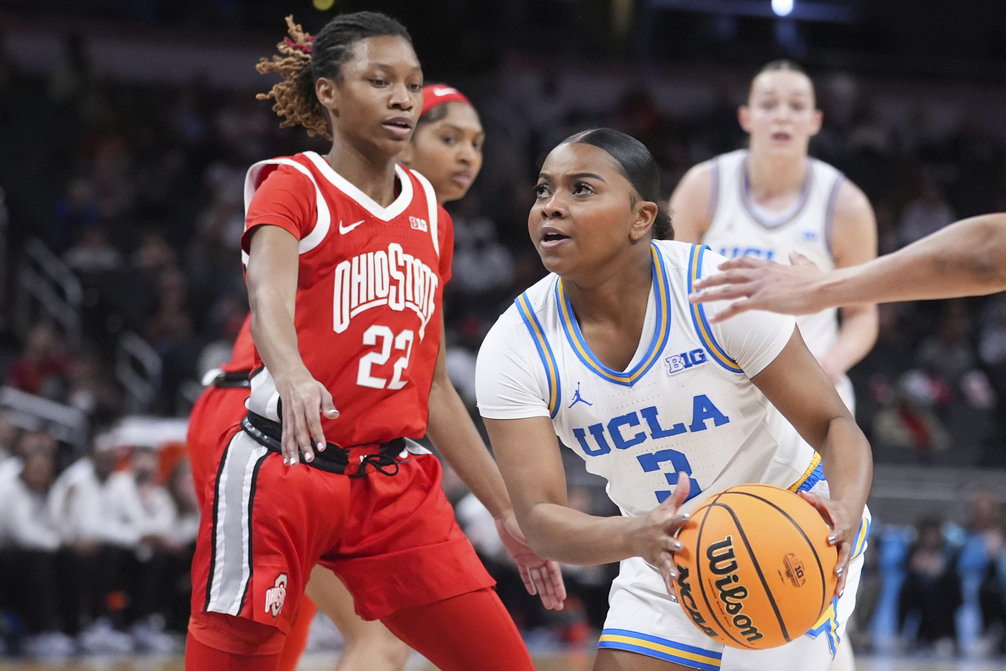 UCLA guard Londynn Jones (3) drives on Ohio State guard Jaloni Cambridge (22) during the first half of an NCAA college basketball game in the semifinals of the Big Ten Conference tournament in Indianapolis, Saturday, March 8, 2025. 