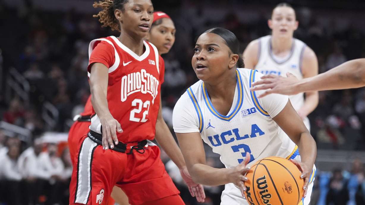 UCLA guard Londynn Jones (3) drives on Ohio State guard Jaloni Cambridge (22) during the first half of an NCAA college basketball game in the semifinals of the Big Ten Conference tournament in Indianapolis, Saturday, March 8, 2025.