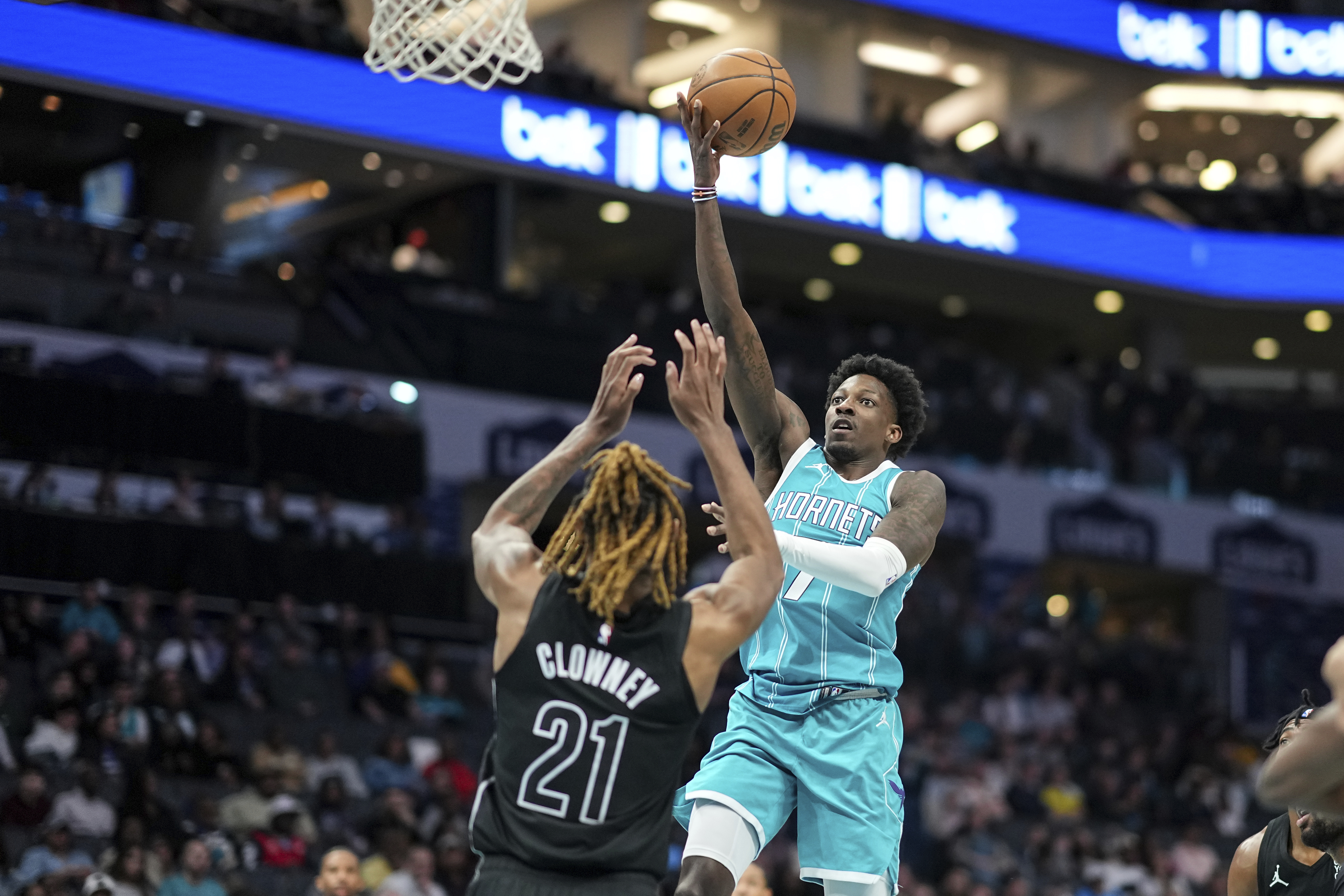 Charlotte Hornets guard Damion Baugh, center right, drives to the basket against Brooklyn Nets forward Noah Clowney (21) during the first half of an NBA basketball game, Saturday, March 8, 2025, in Charlotte, N.C.