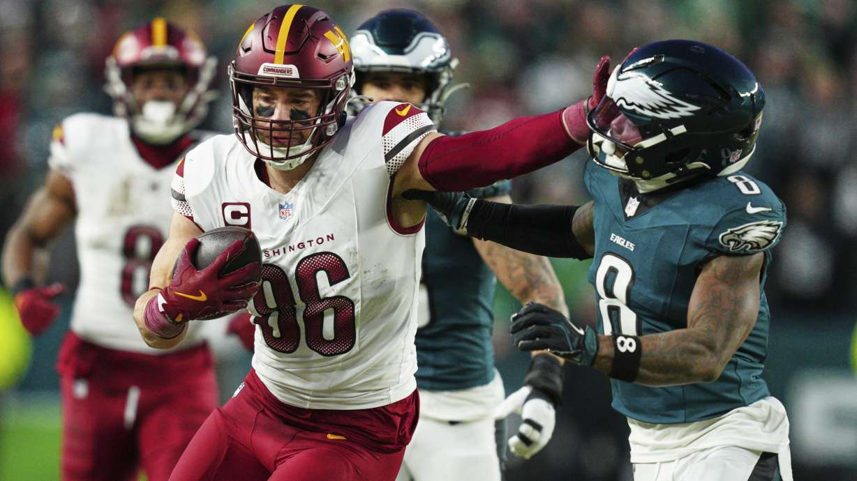 FILE - Washington Commanders tight end Zach Ertz (86) stiff arms Philadelphia Eagles safety C.J. Gardner-Johnson (8) during the second half of the NFC Championship NFL football game, Jan. 26, 2025, in Philadelphia.
