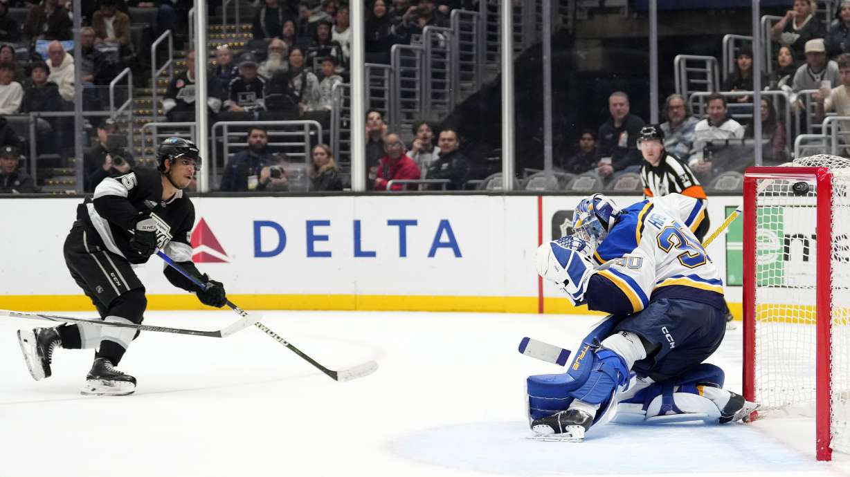 Los Angeles Kings right wing Quinton Byfield, left, scores a game-winner on St. Louis Blues goaltender Joel Hofer during overtime of an NHL hockey game, Saturday, March 8, 2025, in Los Angeles.