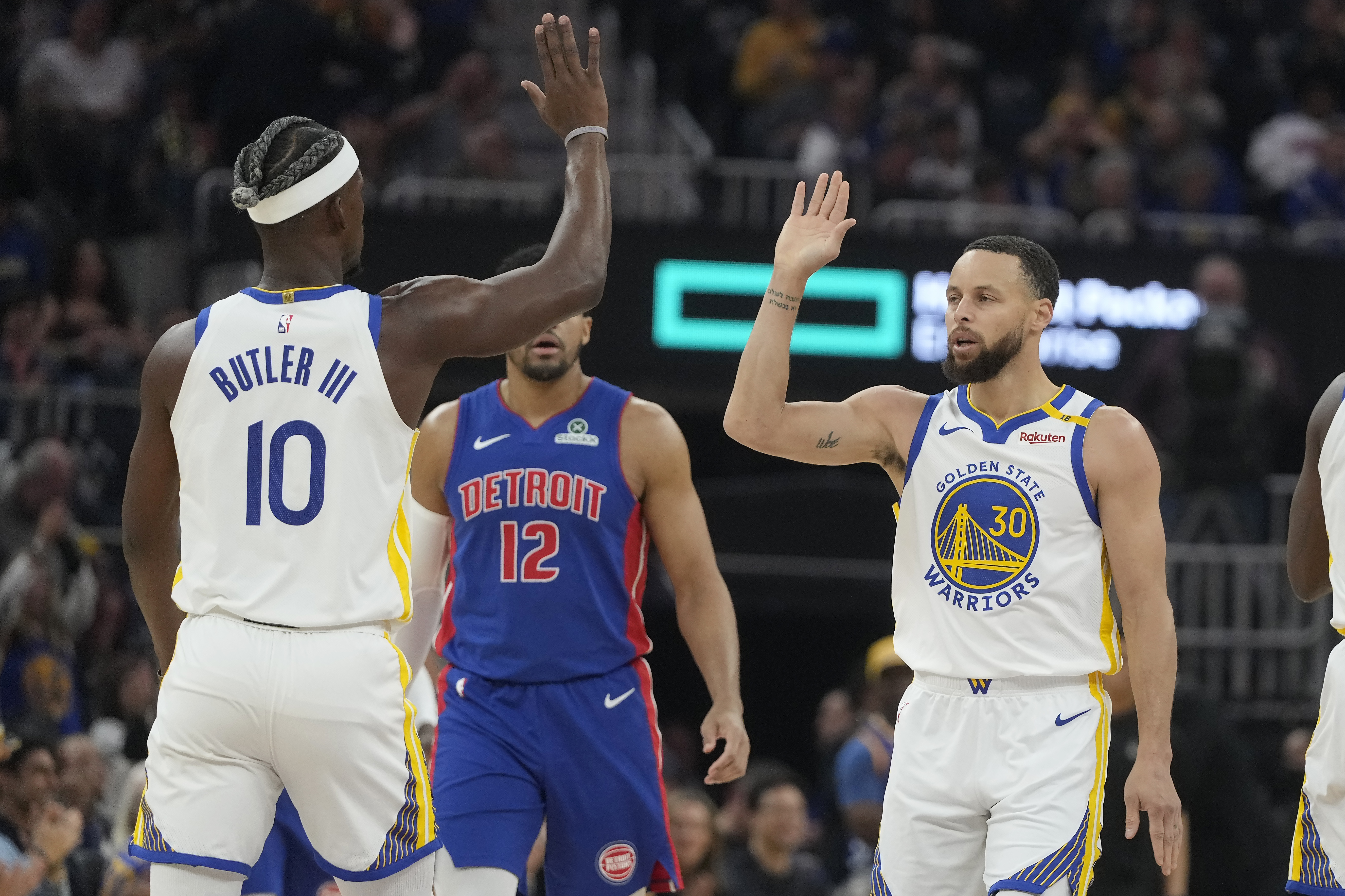 Golden State Warriors guard Stephen Curry (30) is congratulated by forward Jimmy Butler III (10) after making a three-point basket during the first half of an NBA basketball game against the Detroit Pistons in San Francisco, Saturday, March 8, 2025.
