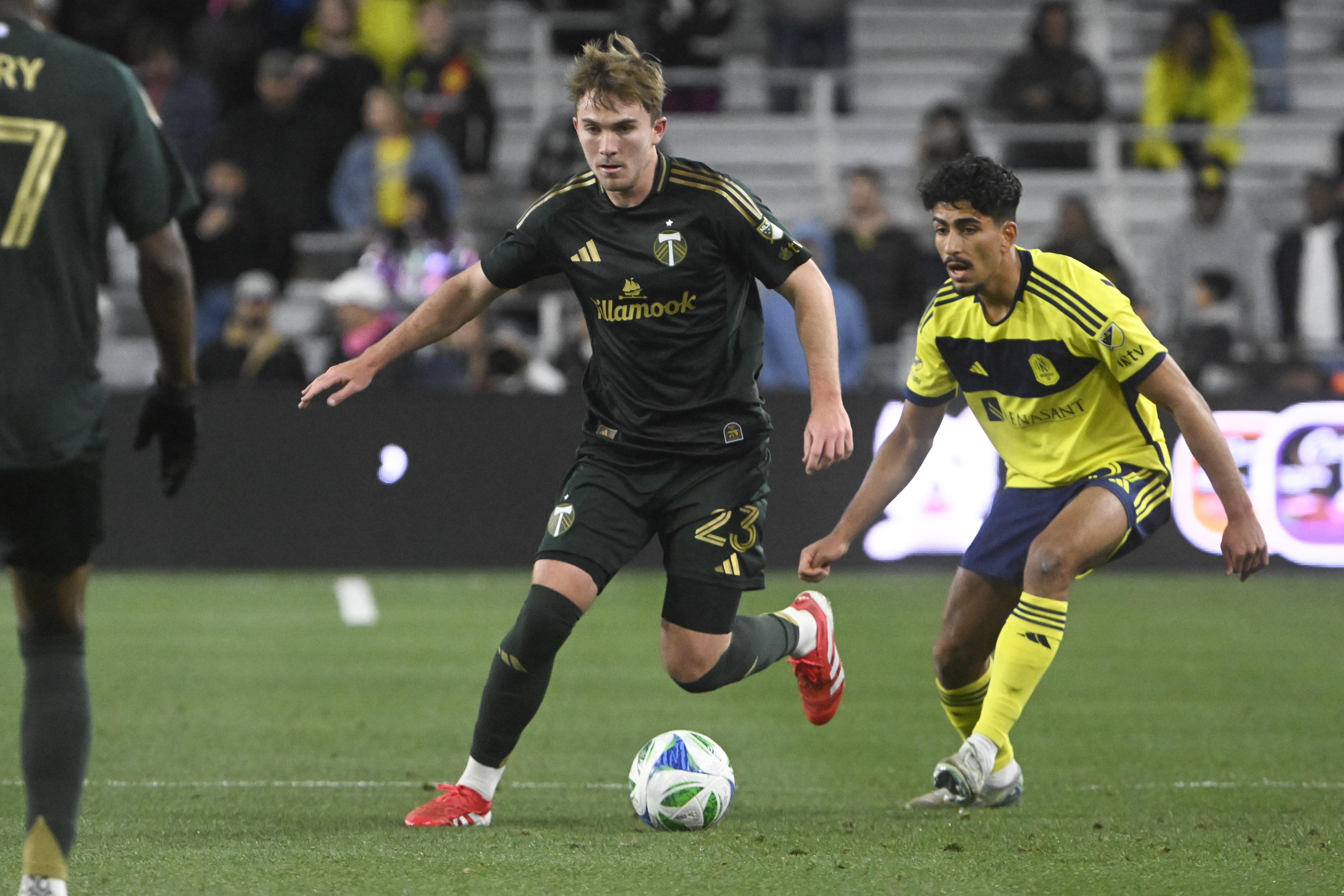 Portland Timbers defender Ian Smith (23) moves the ball as Nashville SC defender Andy Najar, right, defends during the first half of an MLS soccer match Saturday, March 8, 2025, in Nashville, Tenn. 