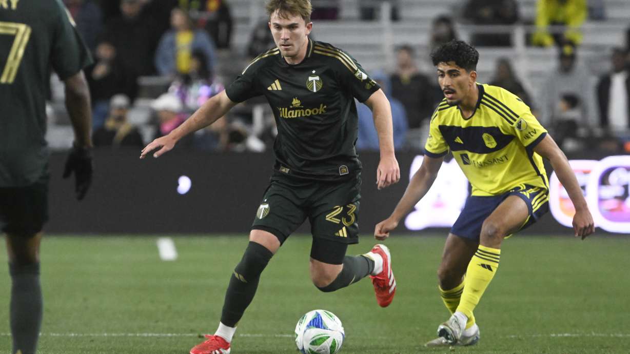 Portland Timbers defender Ian Smith (23) moves the ball as Nashville SC defender Andy Najar, right, defends during the first half of an MLS soccer match Saturday, March 8, 2025, in Nashville, Tenn.