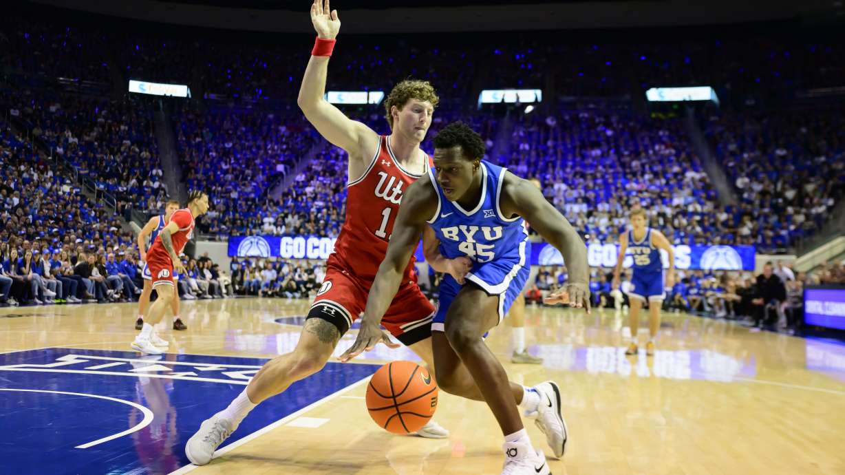 BYU center Fousseyni Traore (45) drives to the basket guarded by Utah forward Caleb Lohner (11) during the first half of an NCAA basketball game Saturday, March 8, 2025, in Provo, Utah.