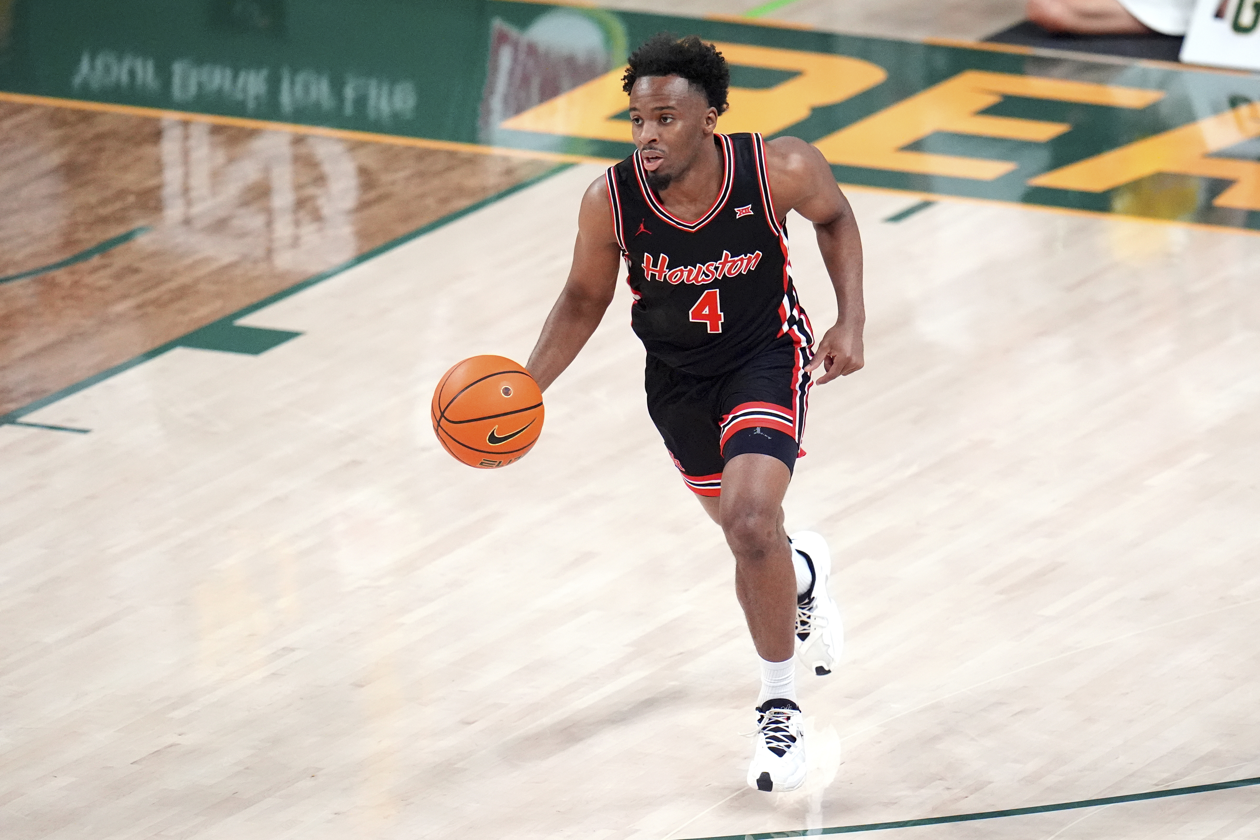 Houston guard L.J. Cryer dribbles the ball up court against the Baylor during the first half of an NCAA college basketball game Saturday, March 8, 2025, in Waco, Texas. 