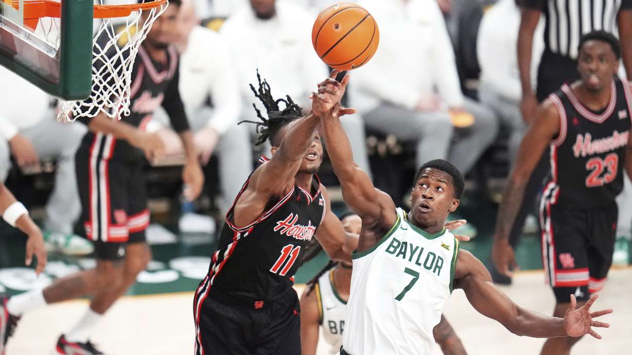 Houston forward Joseph Tugler (11) and Baylor guard VJ Edgecombe (7) compete for a rebound during the first half of an NCAA college basketball game Saturday, March 8, 2025, in Waco, Texas.
