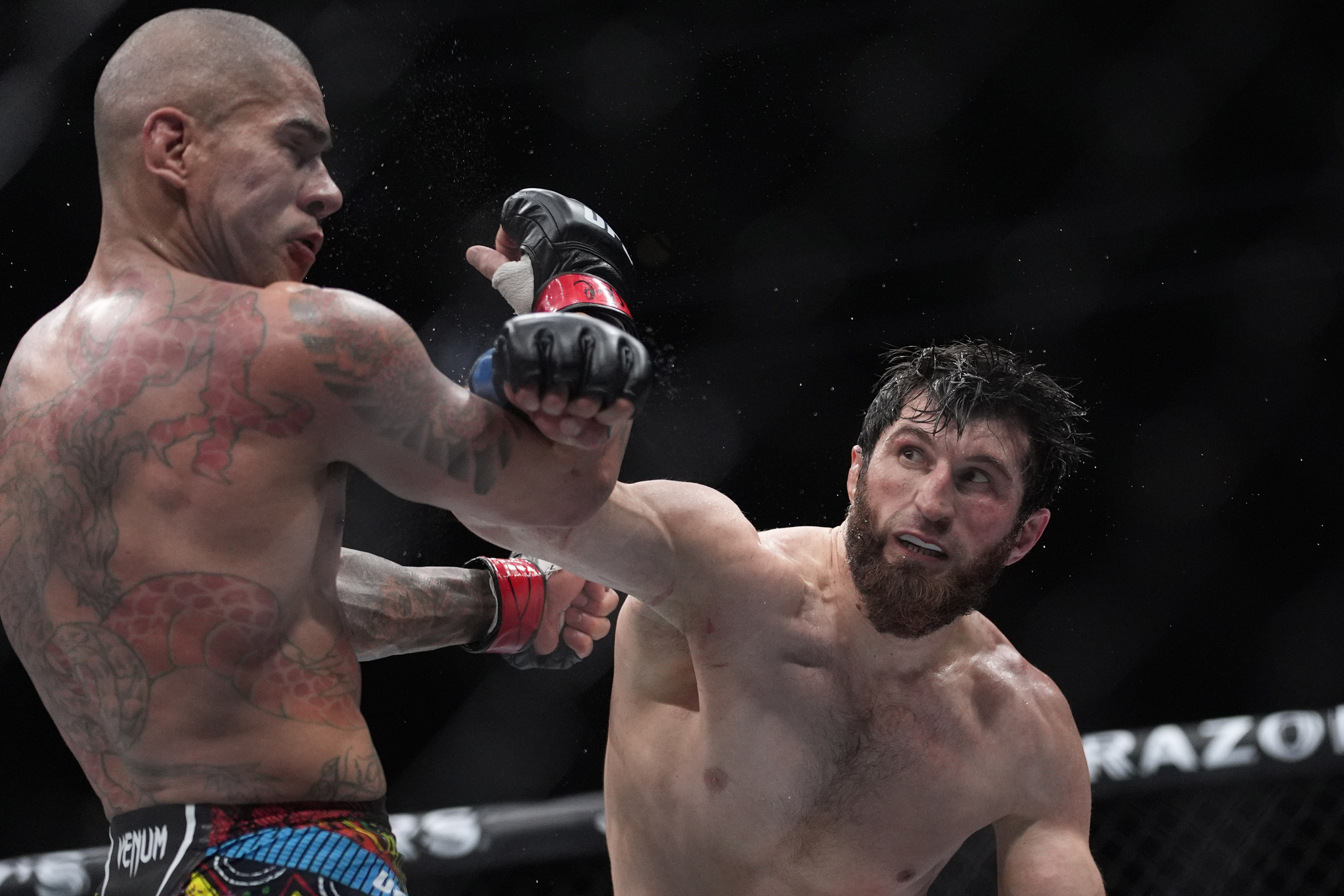 Magomed Ankalaev hits Alex Pereira during a UFC 313 mixed martial arts light heavyweight title bout Saturday, March 8, 2025, in Las Vegas. 
