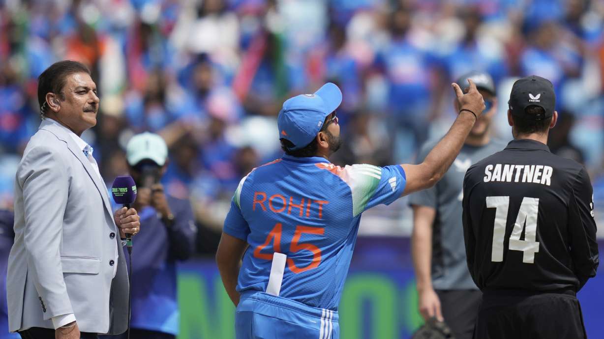 India's captain Rohit Sharma, center, flips the coin at the toss prior to the start of the ICC Champions Trophy final cricket match between India and New Zealand at Dubai International Cricket Stadium in Dubai, United Arab Emirates, Sunday, March 9, 2025.