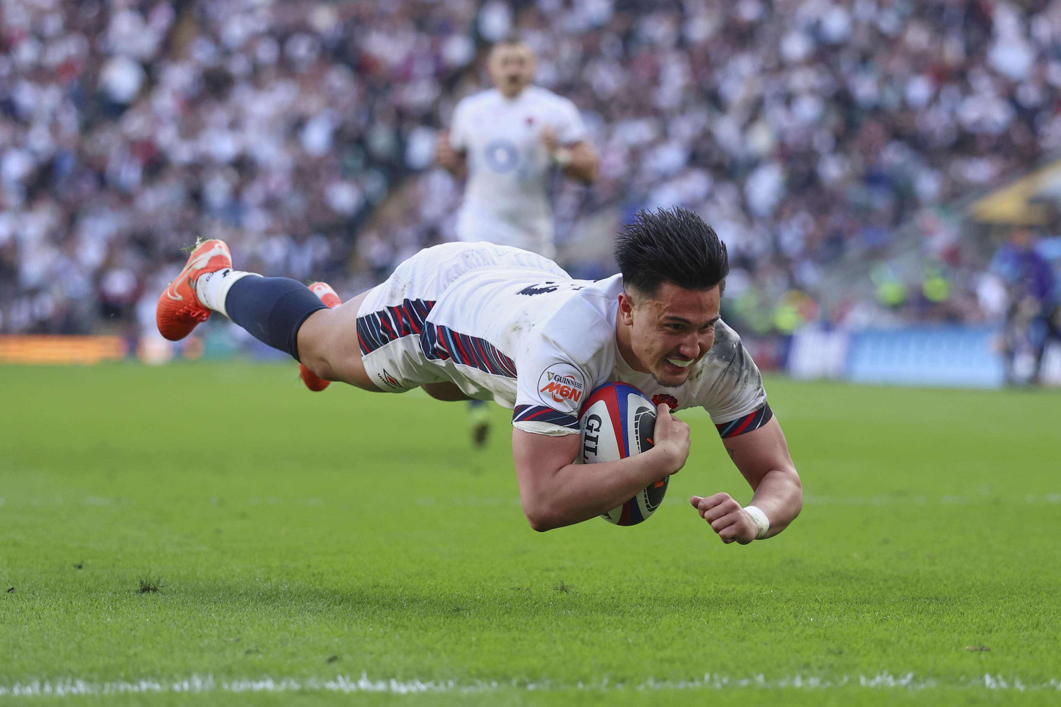 England's Marcus Smith dives over the line to score a try during the Six Nations rugby match between England and Italy at Twickenham stadium in London, Sunday, March 9, 2025.