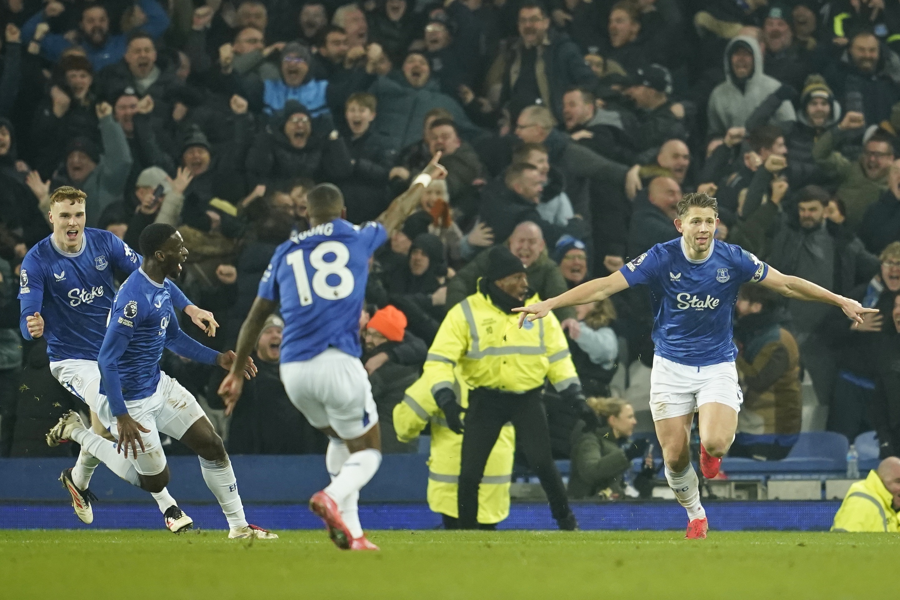Everton's James Tarkowski, right, reacts after scoring his side's second goal during the English Premier League soccer match between Everton and Liverpool, Liverpool, England, Wednesday, Feb.12, 2025. 