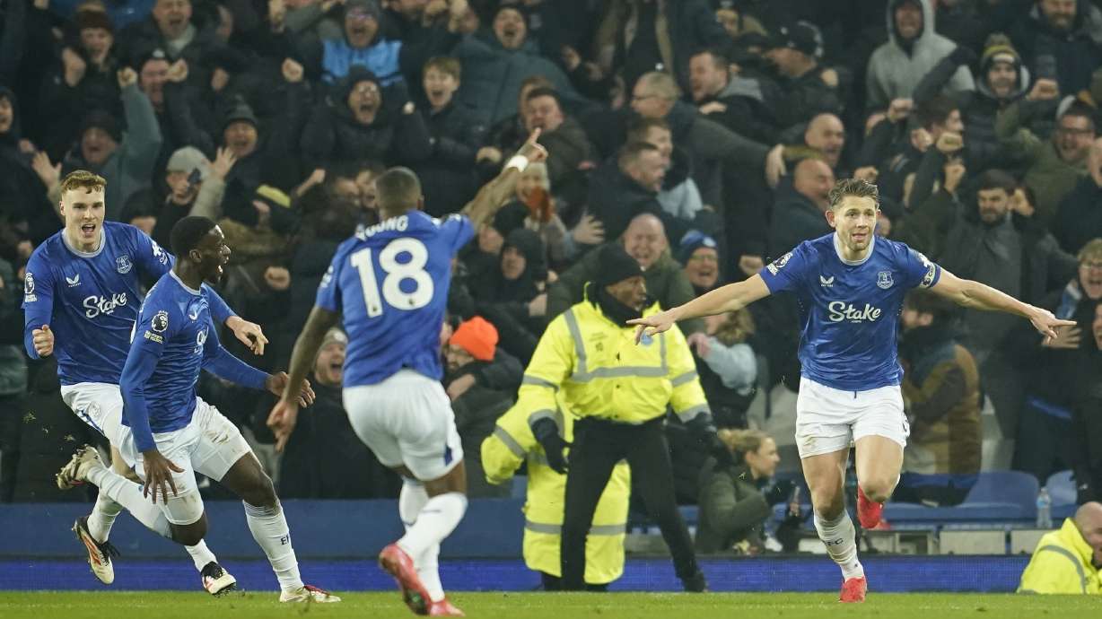 Everton's James Tarkowski, right, reacts after scoring his side's second goal during the English Premier League soccer match between Everton and Liverpool, Liverpool, England, Wednesday, Feb.12, 2025.