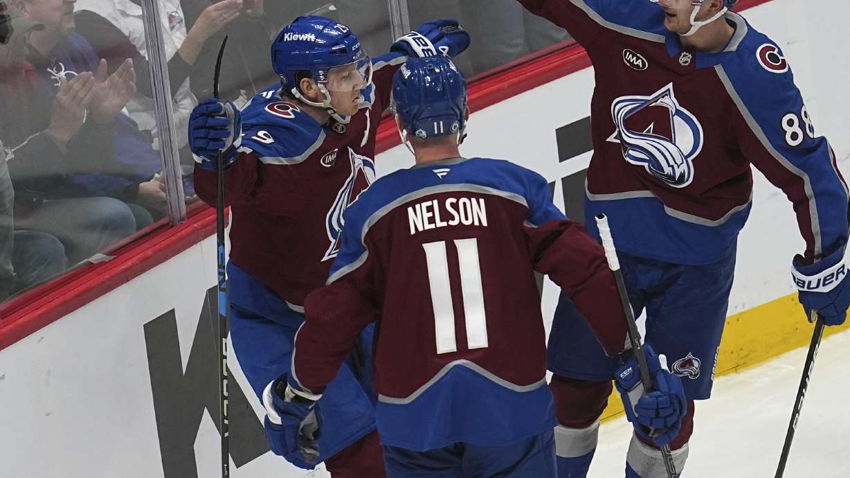Colorado Avalanche center Nathan MacKinnon, left, is congratulated after scoring the go-ahead goal by center Martin Necas, right, and center Brock Nelson (11) in the third period of an NHL hockey game against the Toronto Maple Leafs, Saturday, March 8, 2025, in Denver.