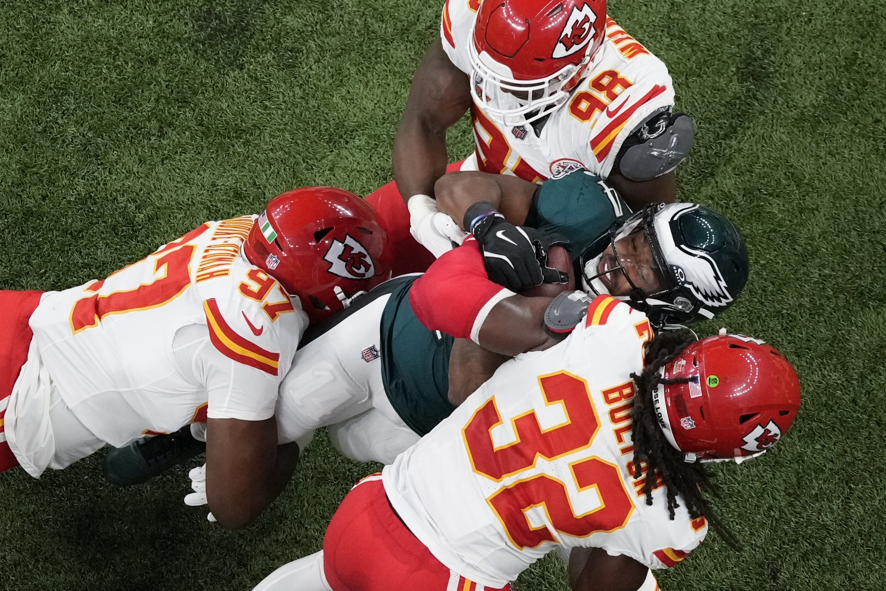 Philadelphia Eagles running back Kenneth Gainwell (14) is tackled by Kansas City Chiefs defensive end Felix Anudike-Uzomah, left to right, defensive tackle Tershawn Wharton and linebacker Nick Bolton during the first half of the NFL Super Bowl 59 football game, Sunday, Feb. 9, 2025, in New Orleans. 