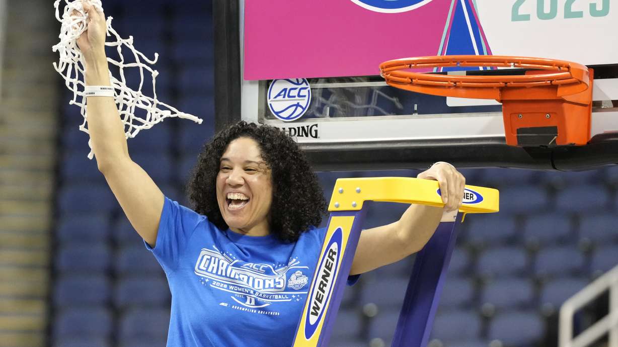 Duke head coach Kara Lawson celebrates after cutting the net after the team defeated North Carolina State in an NCAA college basketball game in the championship of the Atlantic Coast Conference tournament Greensboro, N.C., Sunday, March 9, 2025.