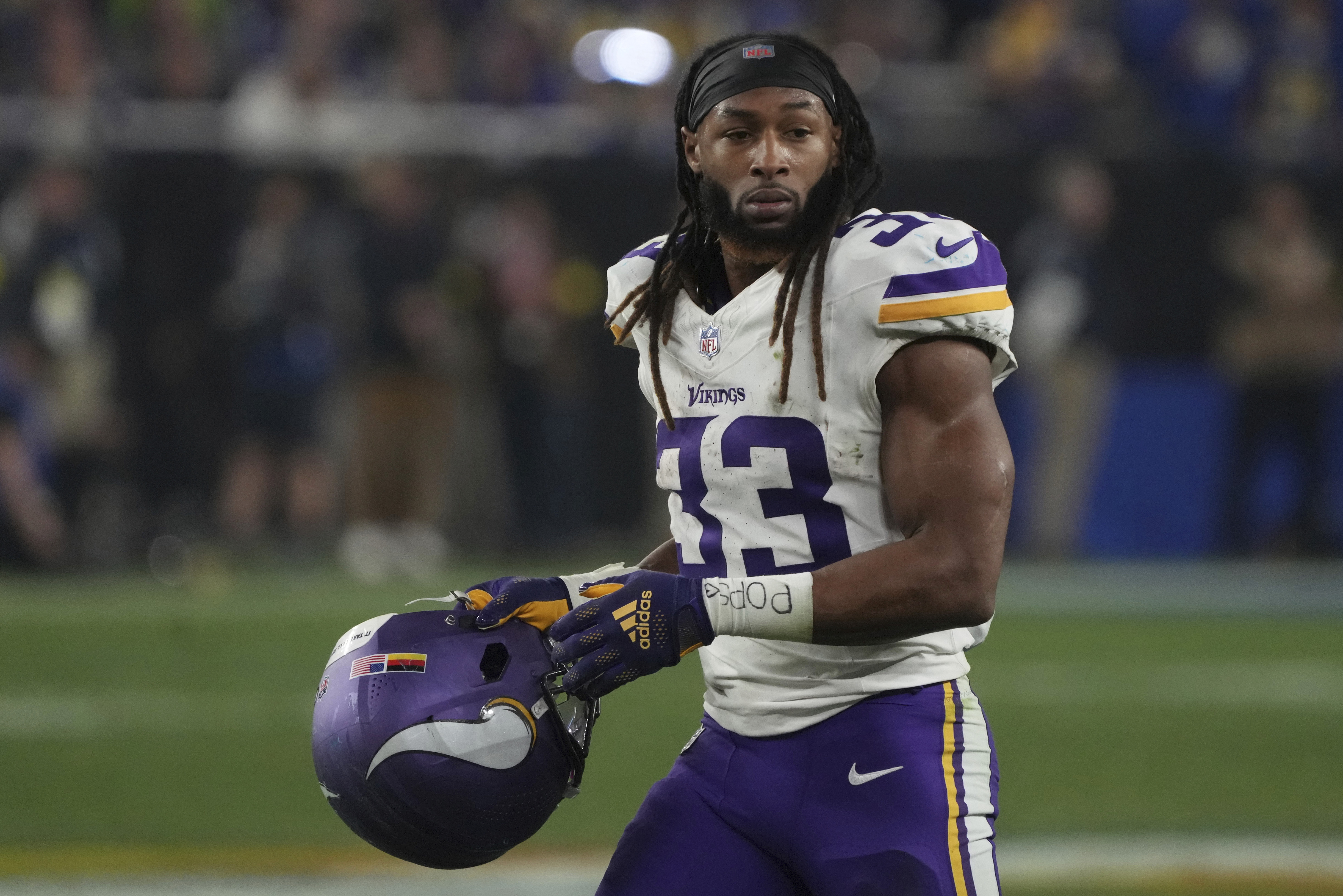 FILE - Minnesota Vikings running back Aaron Jones (33) warms up before an NFL football wild card playoff game against the Los Angeles Rams Monday, Jan. 13, 2025, in Glendale, Ariz. 