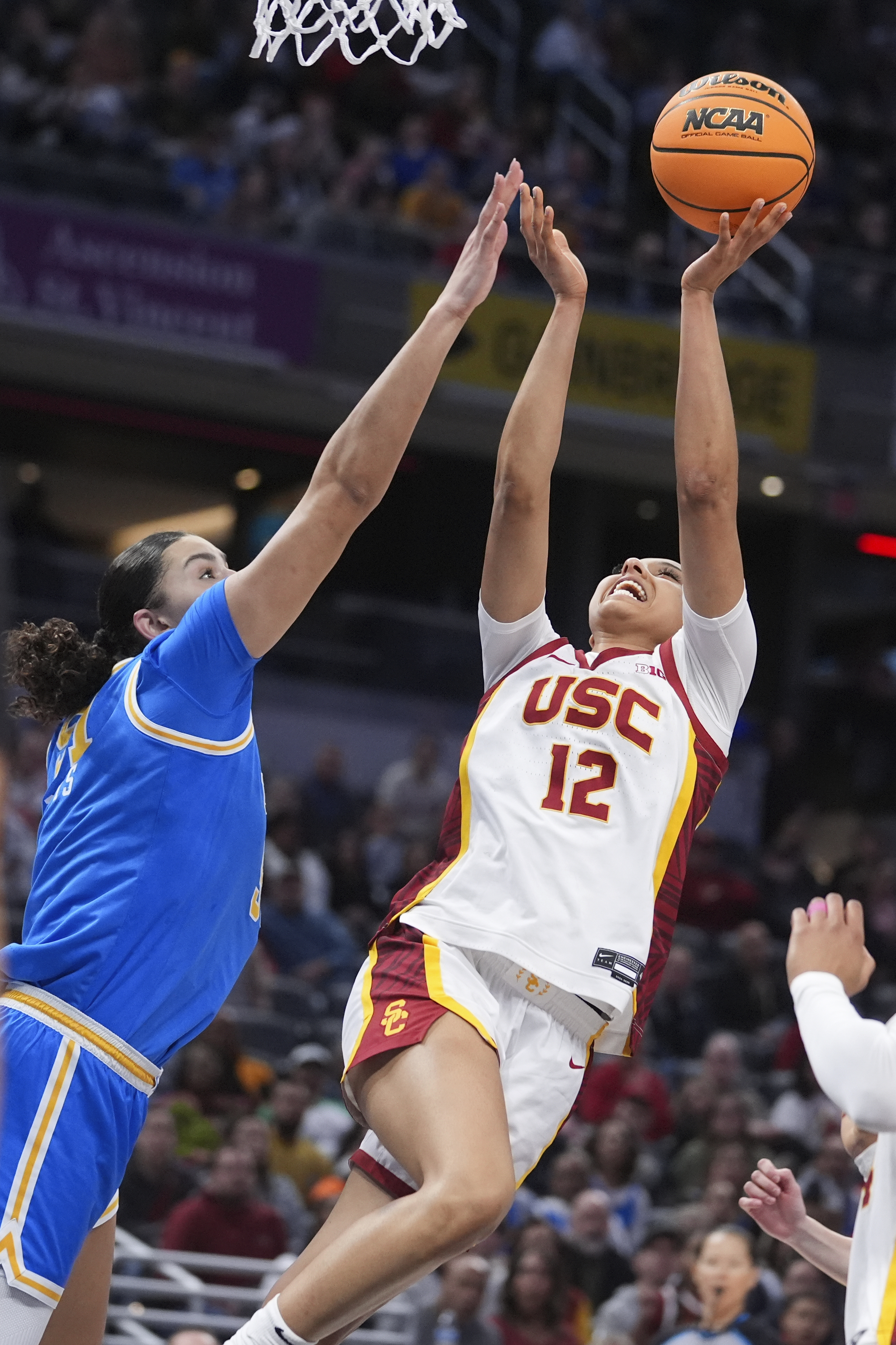 Southern California guard JuJu Watkins (12) shoots on UCLA center Lauren Betts (51) during the first half of an NCAA college basketball game in the championship of the Big Ten Conference tournament in Indianapolis, Sunday, March 9, 2025.