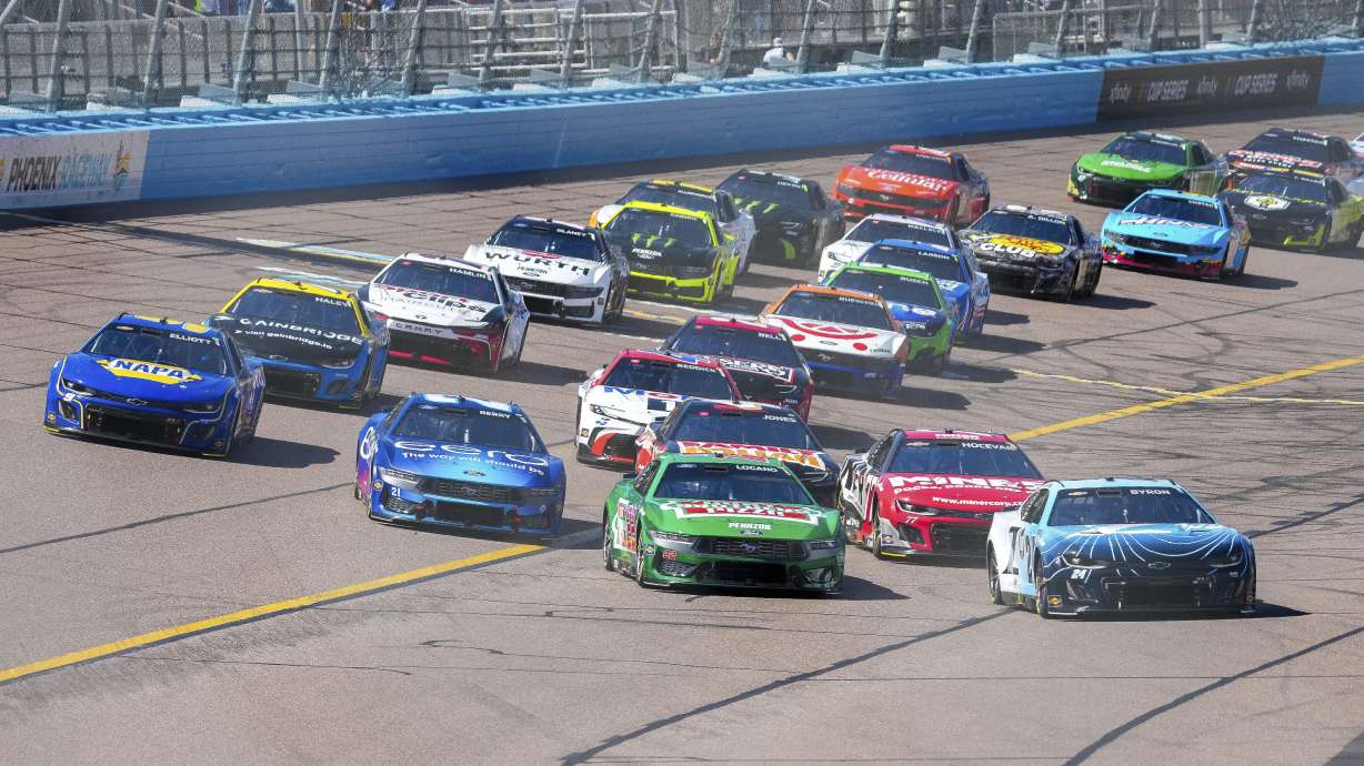 Cars round Turn 4 to start a NASCAR Cup Series auto race at Phoenix Raceway, Sunday, March 9, 2025, in Avondale, Ariz.