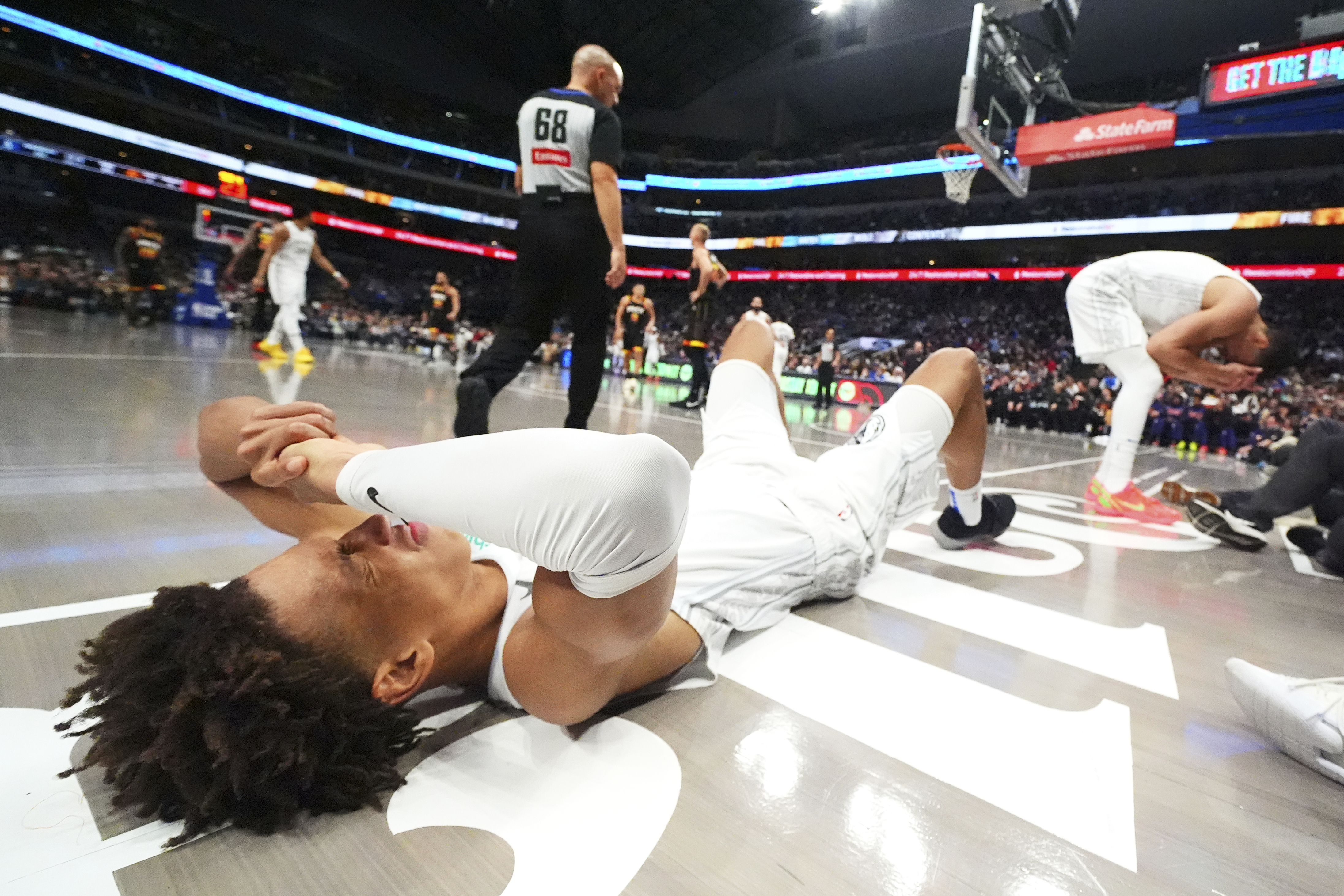 Dallas Mavericks forward Kessler Edwards, left, and center Dwight Powell react after colliding while chasing a rebound against the Phoenix Suns during the second half of an NBA basketball game Sunday, March 9, 2025, in Dallas.