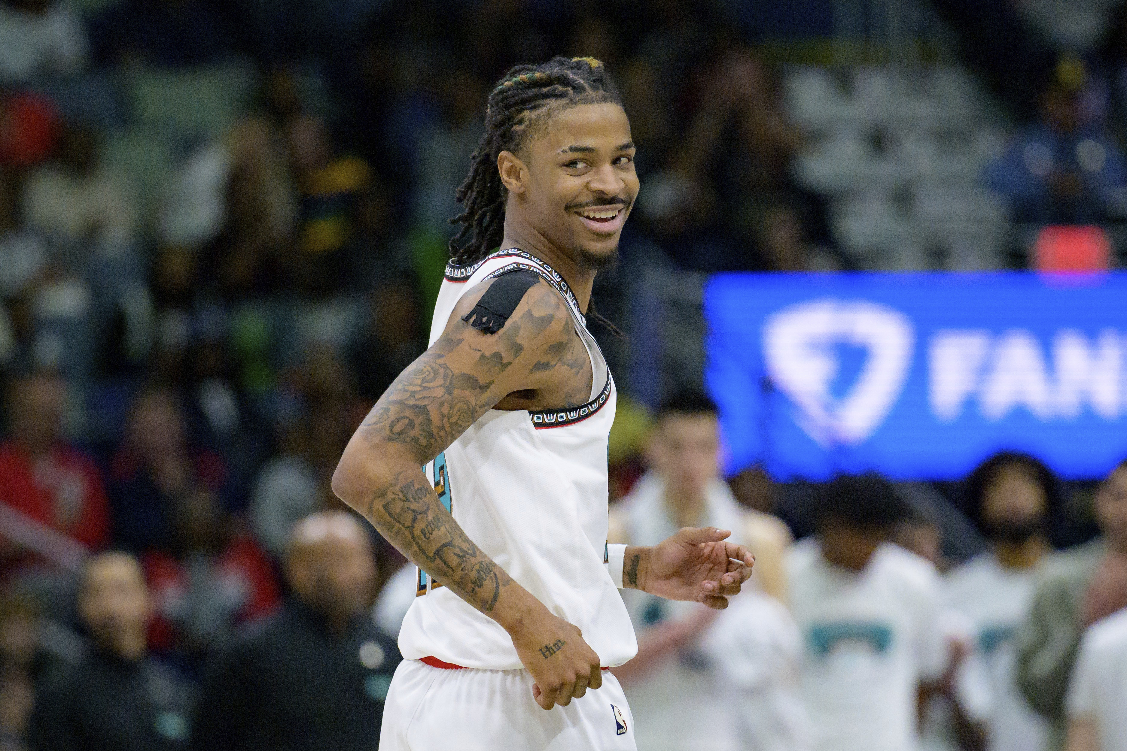 Memphis Grizzlies guard Ja Morant (12) smiles after a three-point basket during the fourth quarter of an NBA basketball game against the New Orleans Pelicans in New Orleans, Sunday, March 9, 2025. 