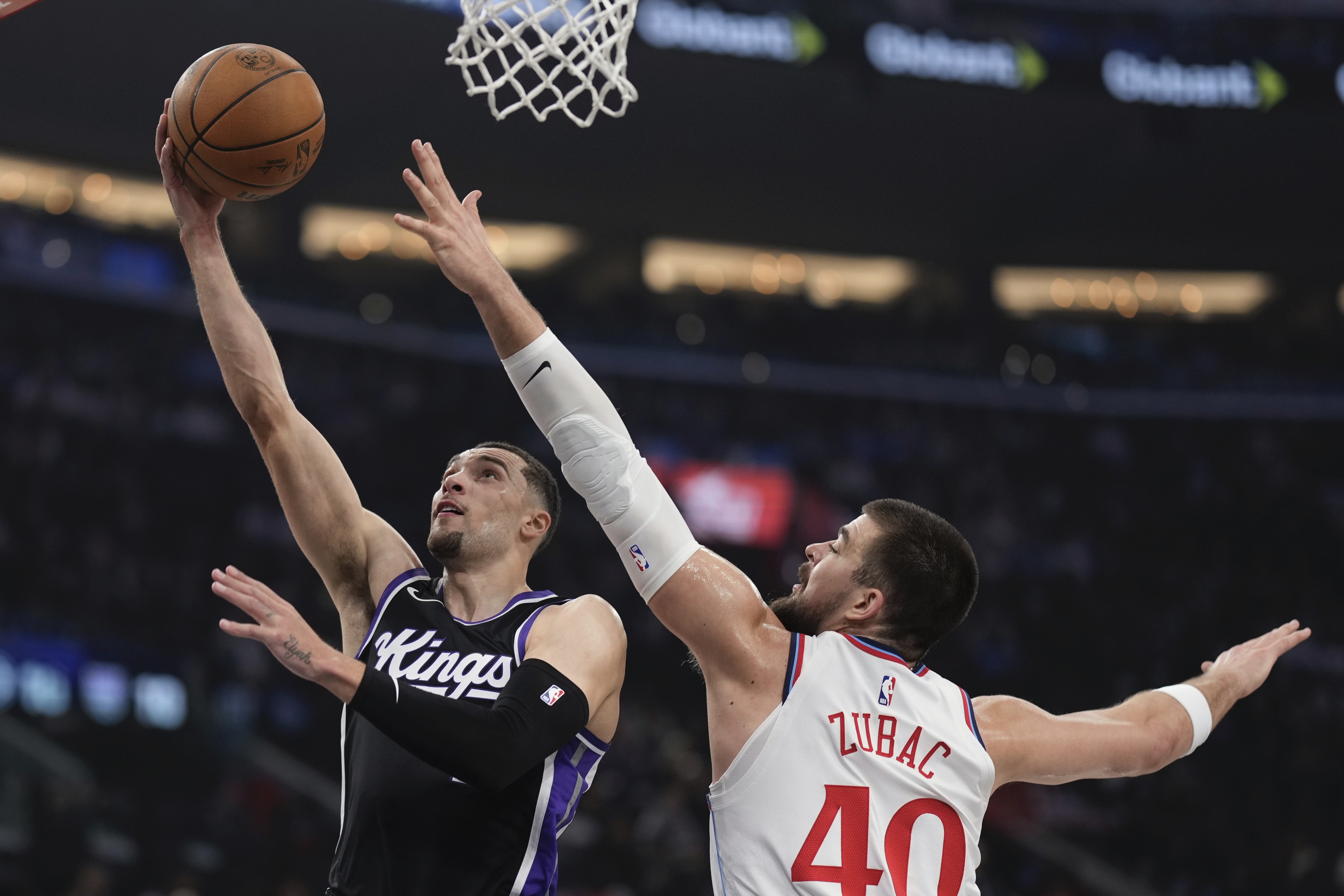 Sacramento Kings guard Zach LaVine, left, shoots as Los Angeles Clippers center Ivica Zubac defends during the first half of an NBA basketball game Sunday, March 9, 2025, in Inglewood, Calif. 