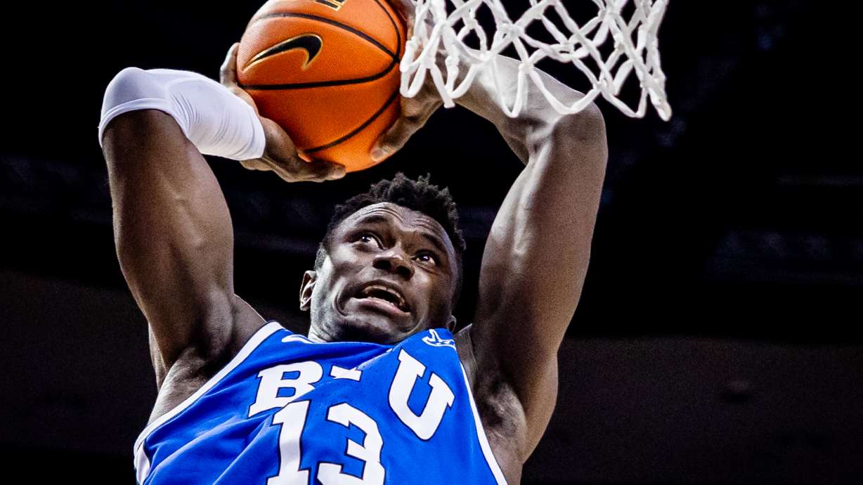 Brigham Young center Keba Keita (13) jumps up to dunk the ball during a basketball game against the Utah Utes at the Marriott Center at Brigham Young University in Provo on Saturday, March 8, 2025.