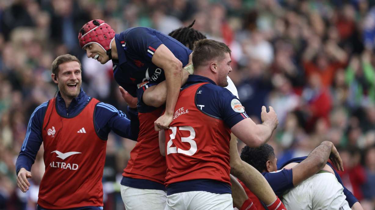 France's Louis Bielle-Biarrey, top, celebrates after his teammate Damian Penaud scored a try during the Six Nations rugby union match between Ireland and France, at Aviva Stadium, Dublin, Ireland, Saturday, March 8, 2025.