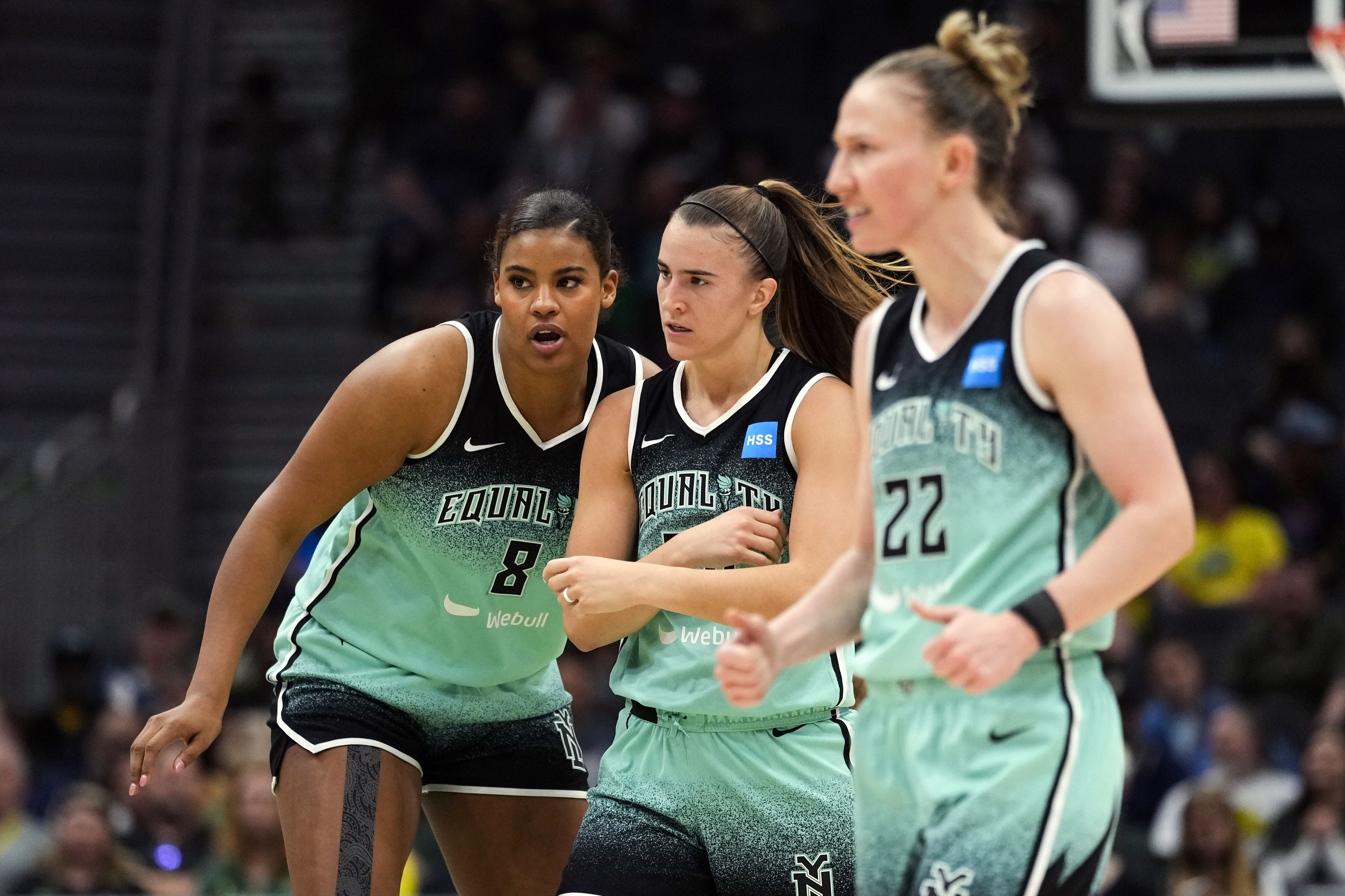 FILE - New York Liberty forward Nyara Sabally (8) reacts with guard Sabrina Ionescu (20) and guard Courtney Vandersloot (22) during the first half of a WNBA basketball game against the Seattle Storm, Tuesday, May 30, 2023, in Seattle. 