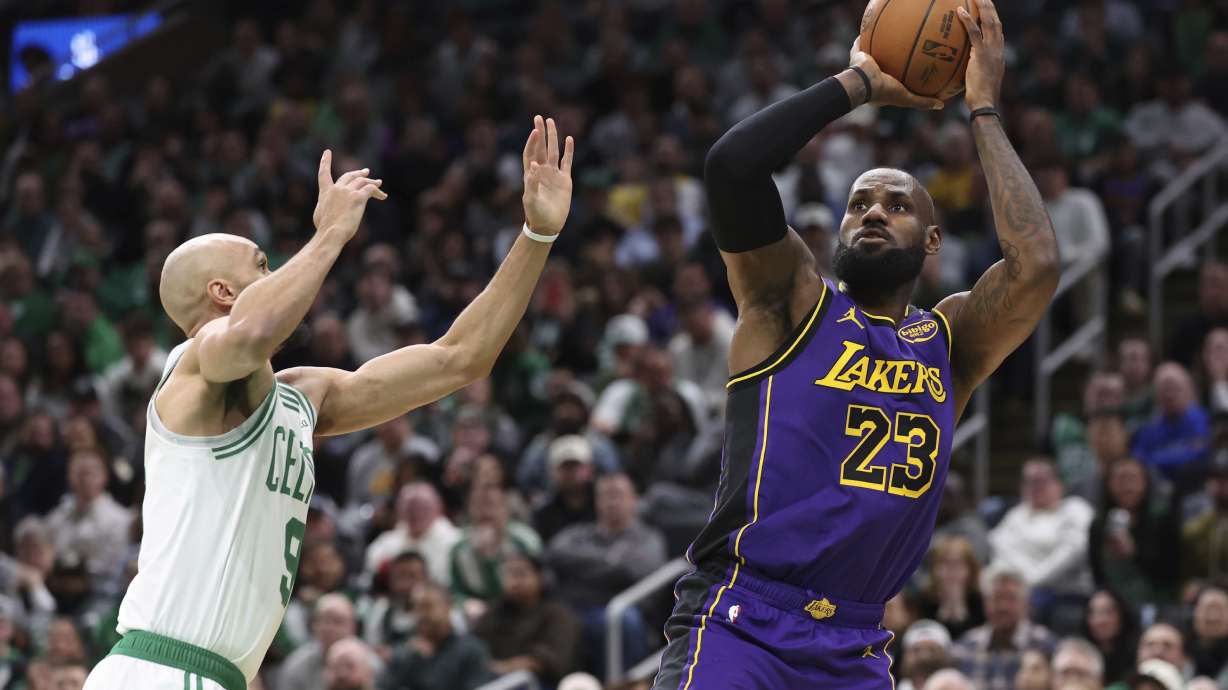 Los Angeles Lakers forward LeBron James (23) makes an outside shot over Boston Celtics guard Derrick White (9) during the first half of an NBA basketball game, Saturday, March 8, 2025, in Boston.