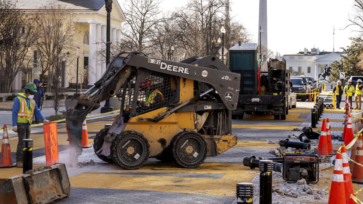 With the White House in the background, demolition begins on the Black Lives Matter mural, Monday, in Washington.