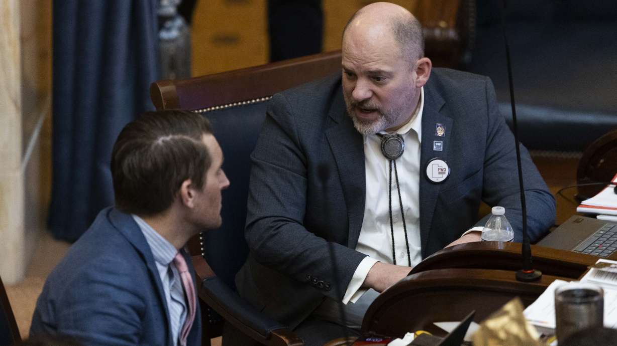 Sen. Daniel Thatcher, right, talks with Sen. Nate Blouin, D-Millcreek, on the floor of the Senate at the state Capitol in Salt Lake City on Friday. Thatcher announced Friday he will leave the Republican Party for the Forward Party.