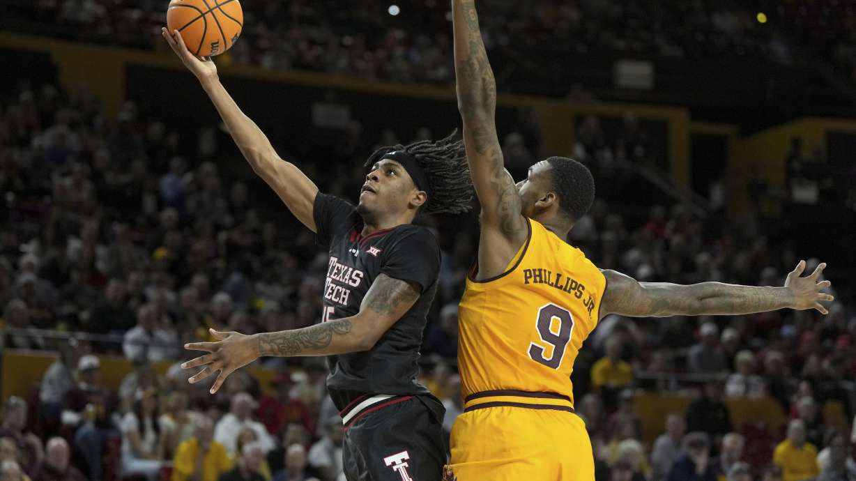 Texas Tech forward JT Toppin drives past Arizona State center Shawn Phillips Jr. (9) during the first half of an NCAA college basketball game, Saturday, March 8, 2025, in Tempe, Ariz.